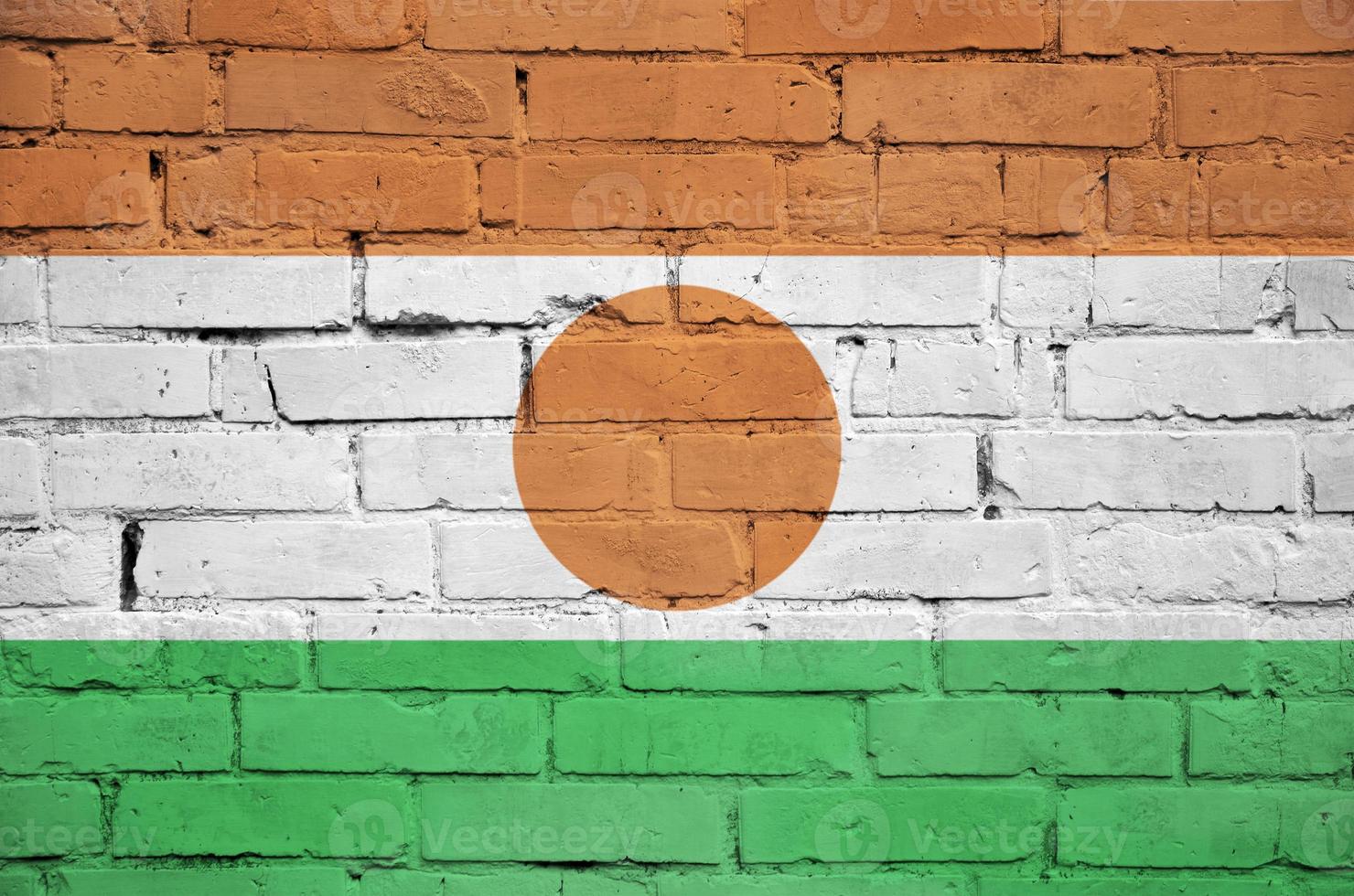 Niger flag is painted onto an old brick wall photo