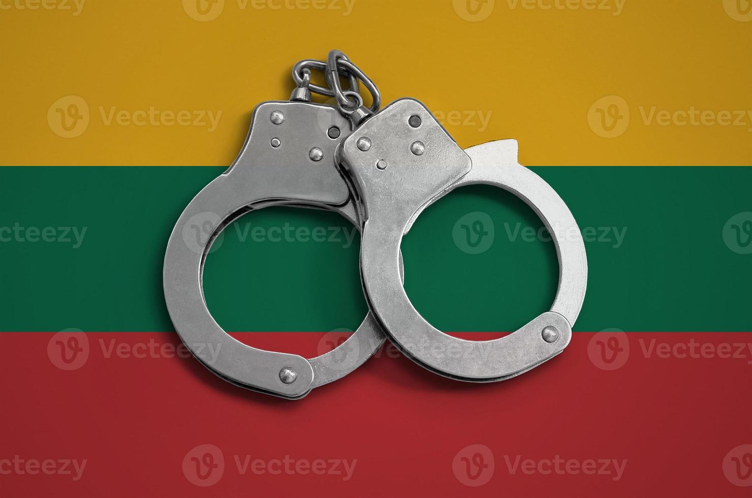 Lithuania flag  and police handcuffs. The concept of observance of the law in the country and protection from crime photo