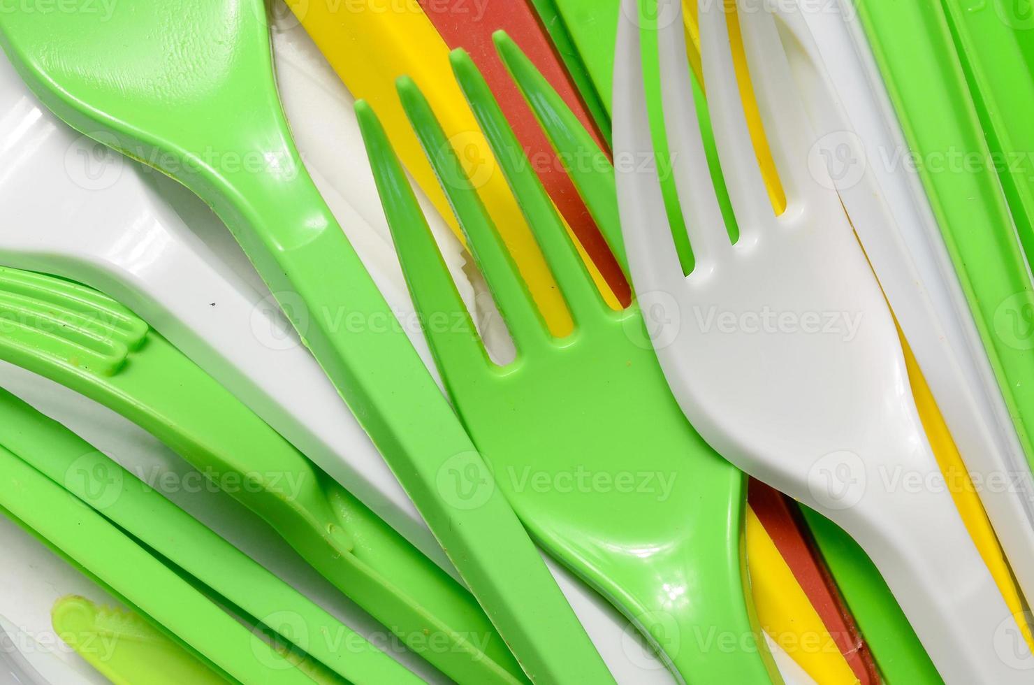 Pile of bright yellow, green and white used plastic kitchenware