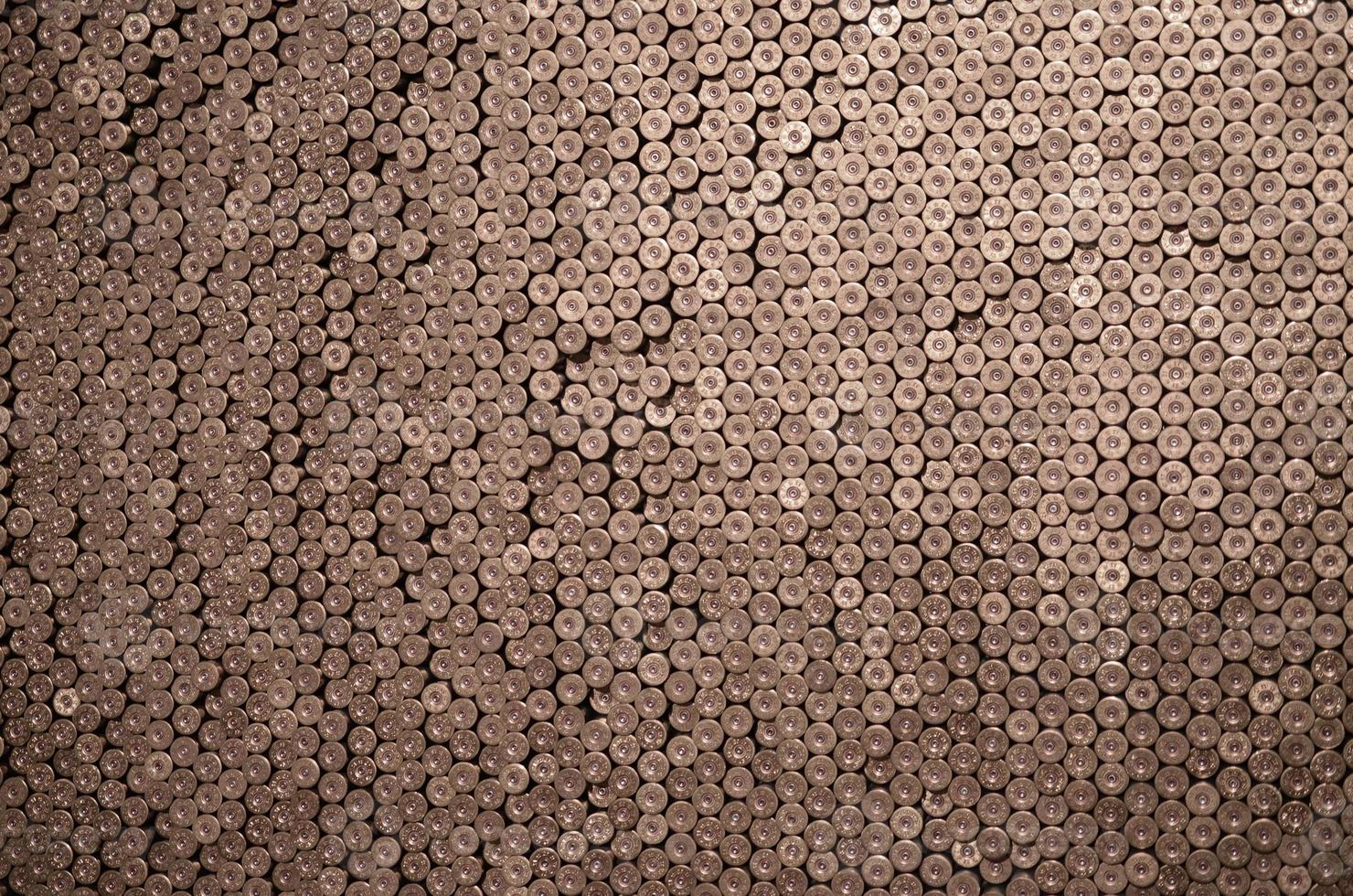 Pattern of 12 gauge cartridges for shotgun bullets. Shells for hunting rifle close up. Backdrop for shooting range or ammunition trade concepts photo