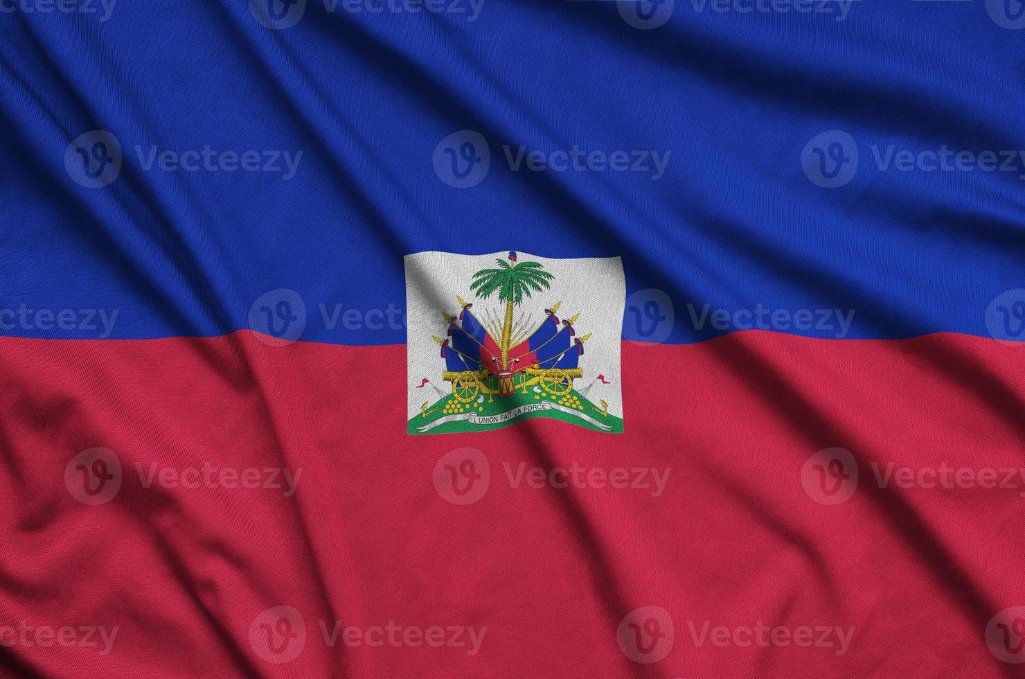 Haiti flag  is depicted on a sports cloth fabric with many folds. Sport team banner photo