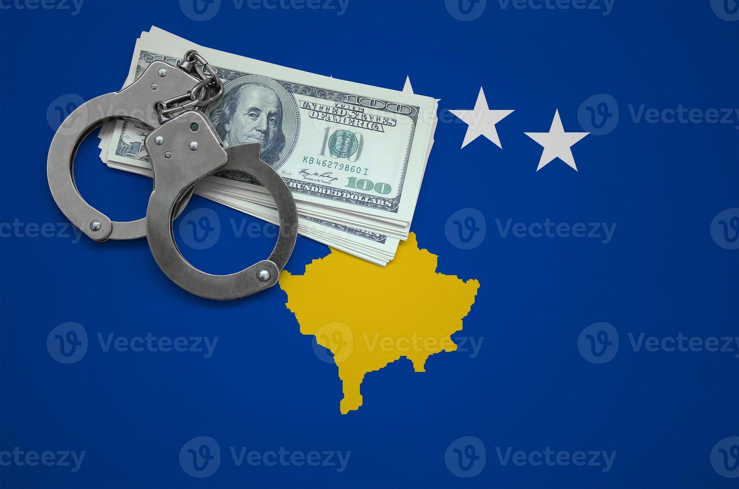 Kosovo flag  with handcuffs and a bundle of dollars. The concept of breaking the law and thieves crimes photo