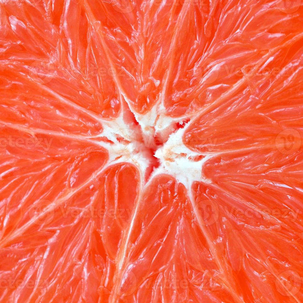 Top view of a fragment of the grapefruit slice close up. Macro background texture photo