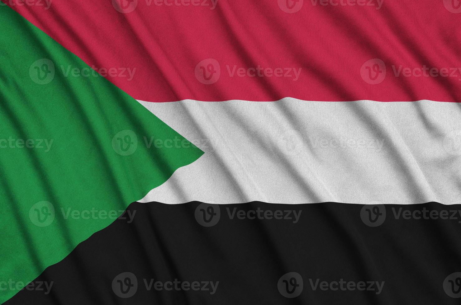 Sudan flag  is depicted on a sports cloth fabric with many folds. Sport team banner photo