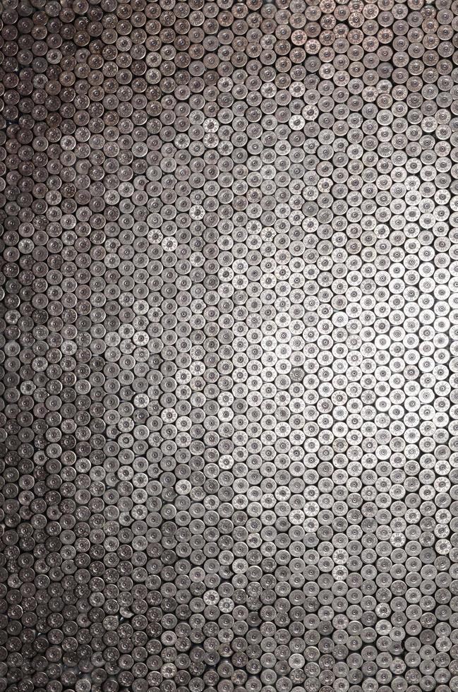 Pattern of 12 gauge cartridges for shotgun bullets. Shells for hunting rifle close up. Backdrop for shooting range or ammunition trade concepts photo