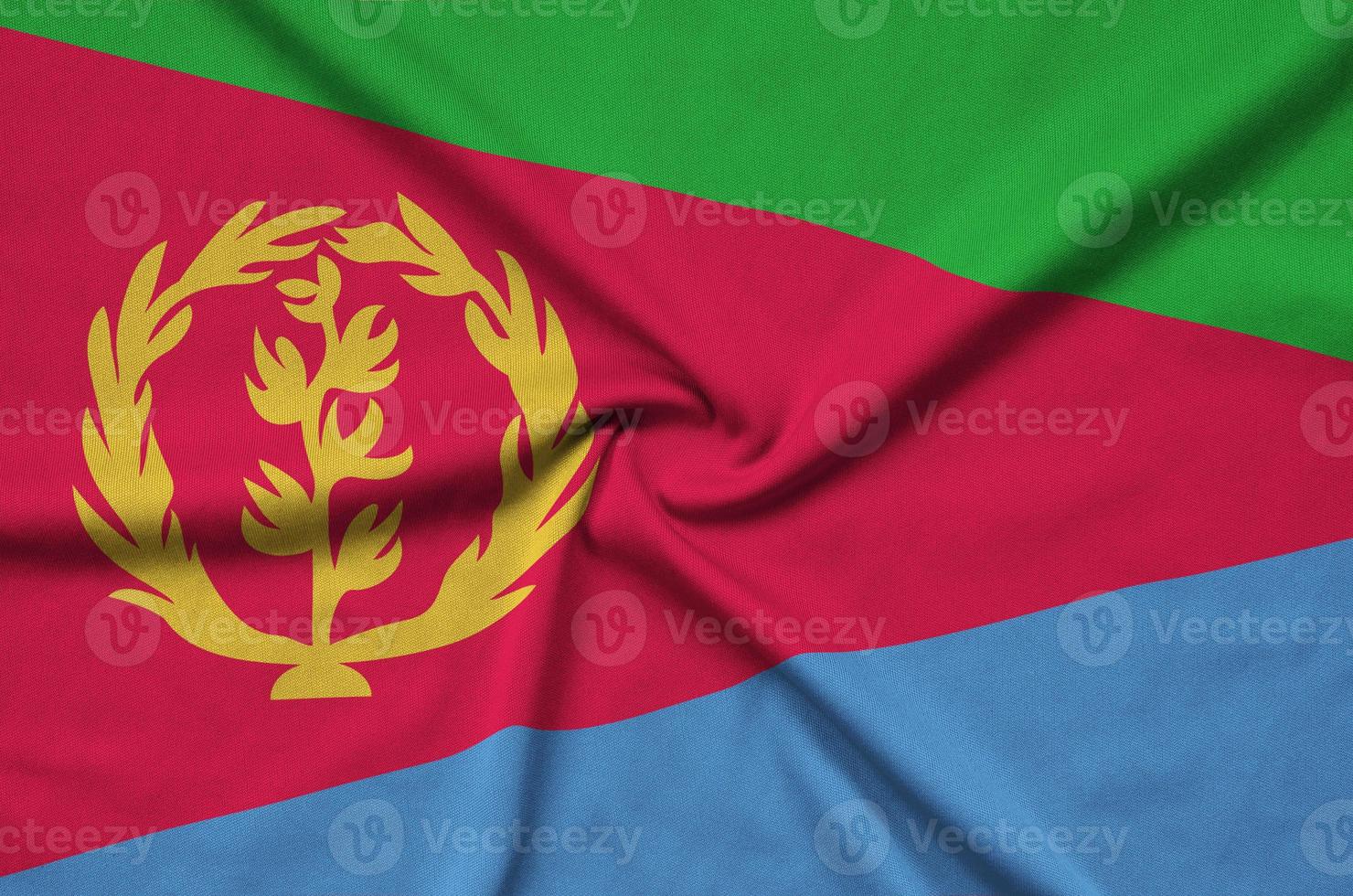 Eritrea flag  is depicted on a sports cloth fabric with many folds. Sport team banner photo