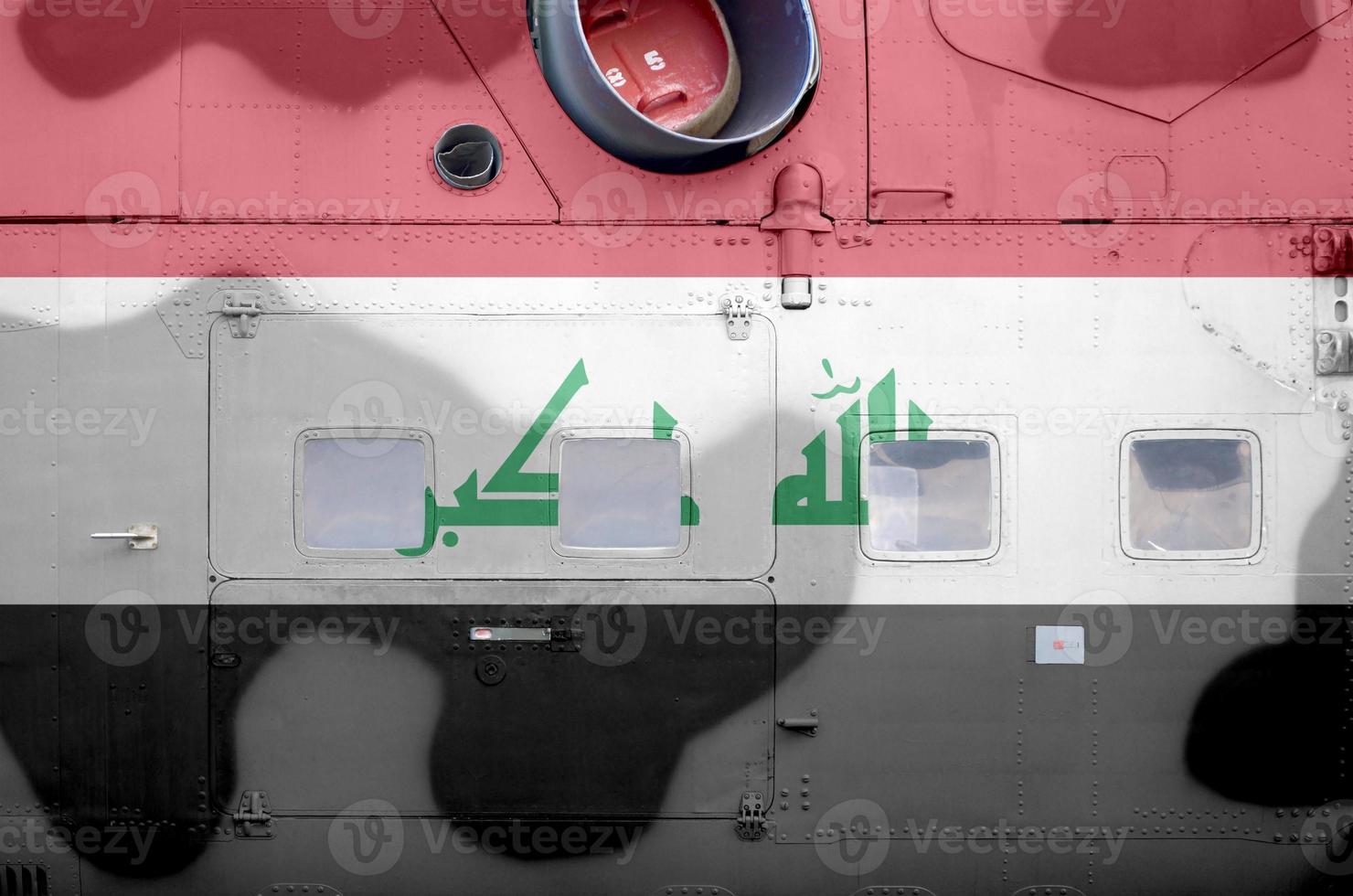 Iraq flag depicted on side part of military armored helicopter closeup. Army forces aircraft conceptual background photo