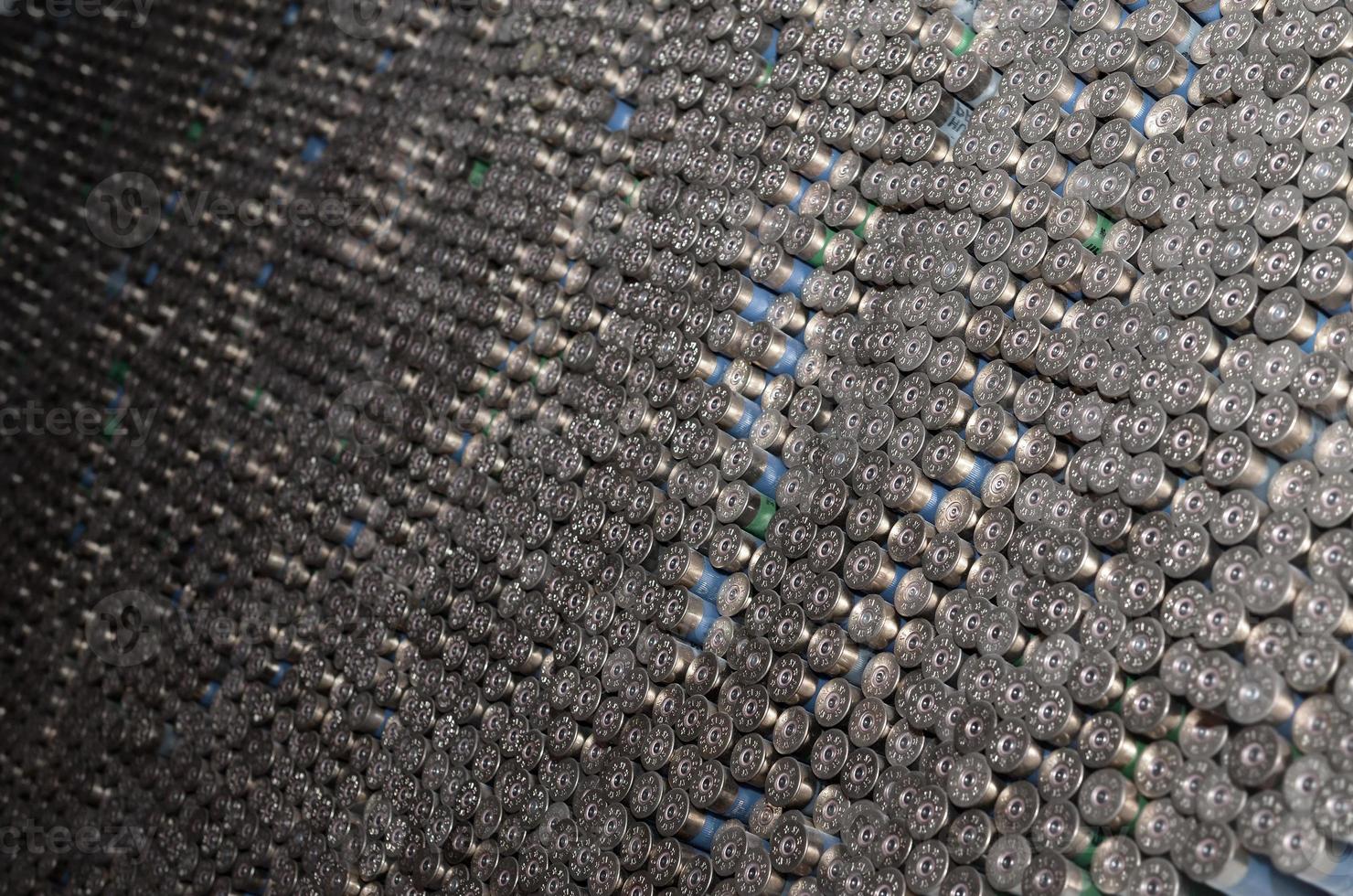 Pattern of 12 gauge cartridges for shotgun bullets. Shells for hunting rifle close up. Backdrop for shooting range or ammunition trade concepts photo