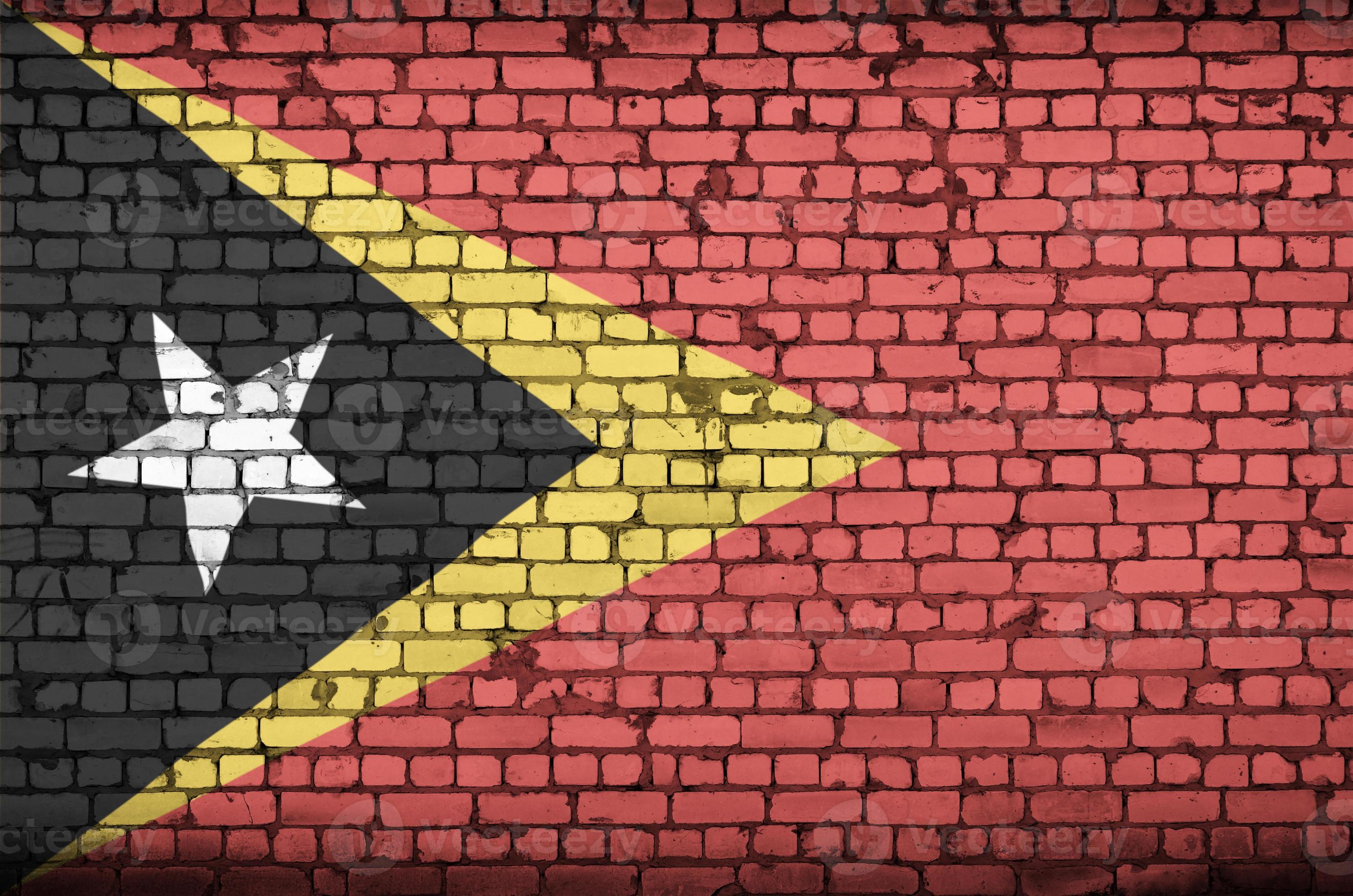 Timor Leste flag is painted onto an old brick wall 14190445 Stock Photo