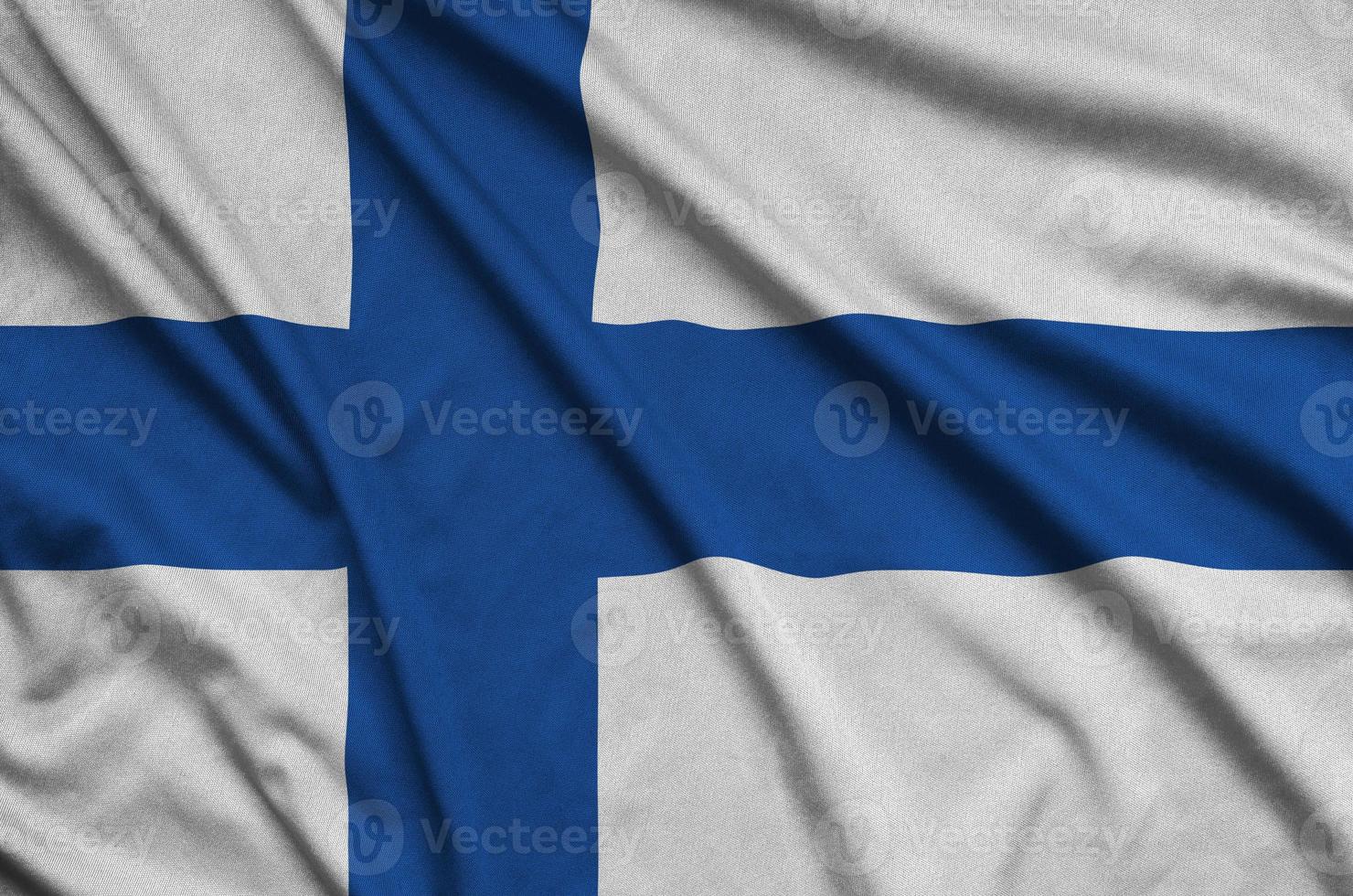 Finland flag  is depicted on a sports cloth fabric with many folds. Sport team banner photo