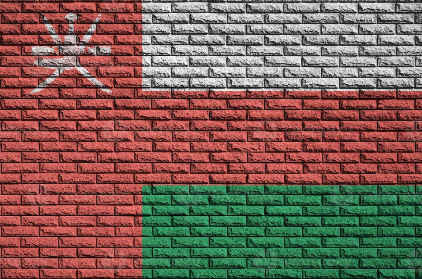 Oman flag is painted onto an old brick wall photo