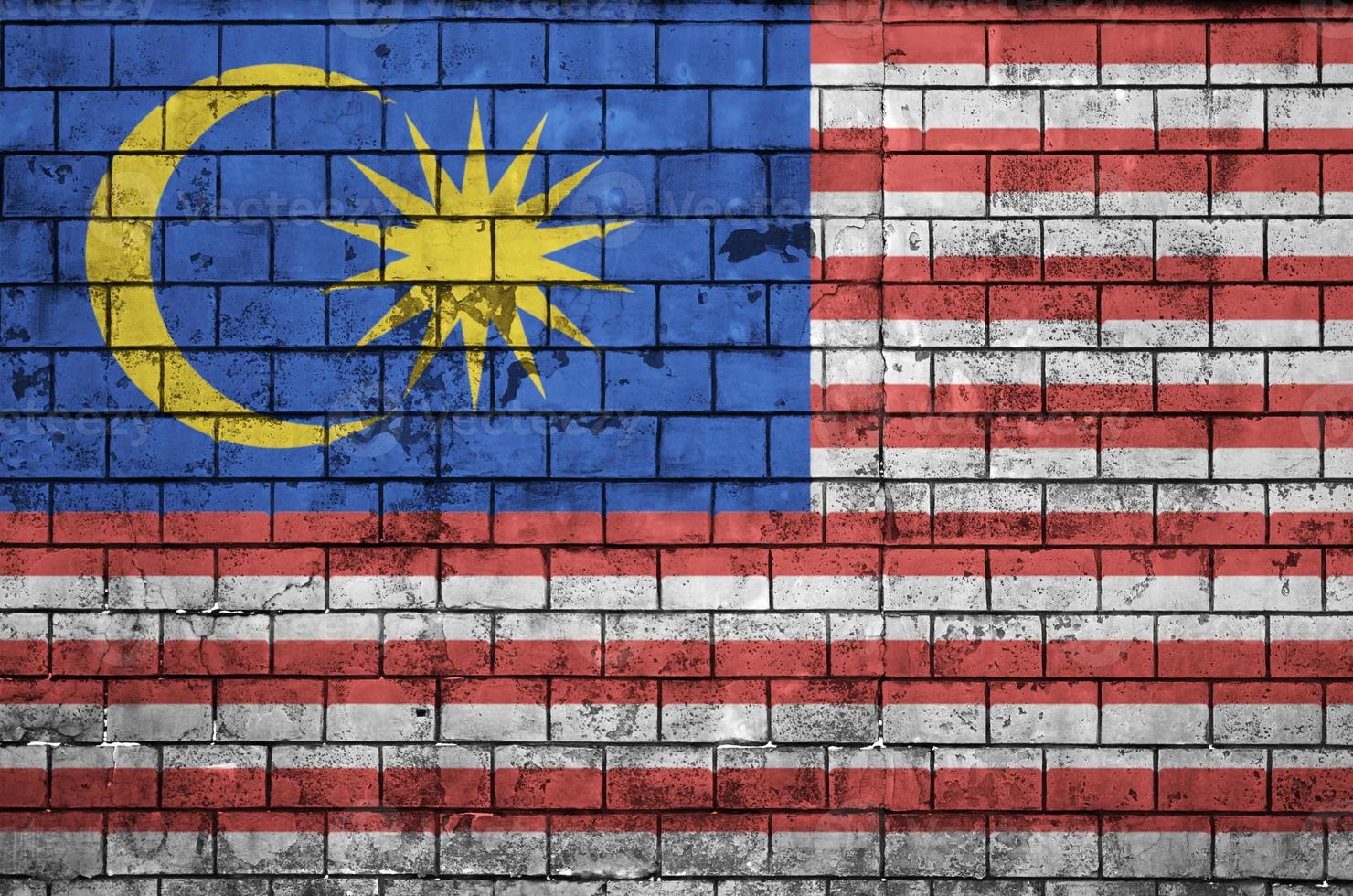 Malaysia flag is painted onto an old brick wall photo