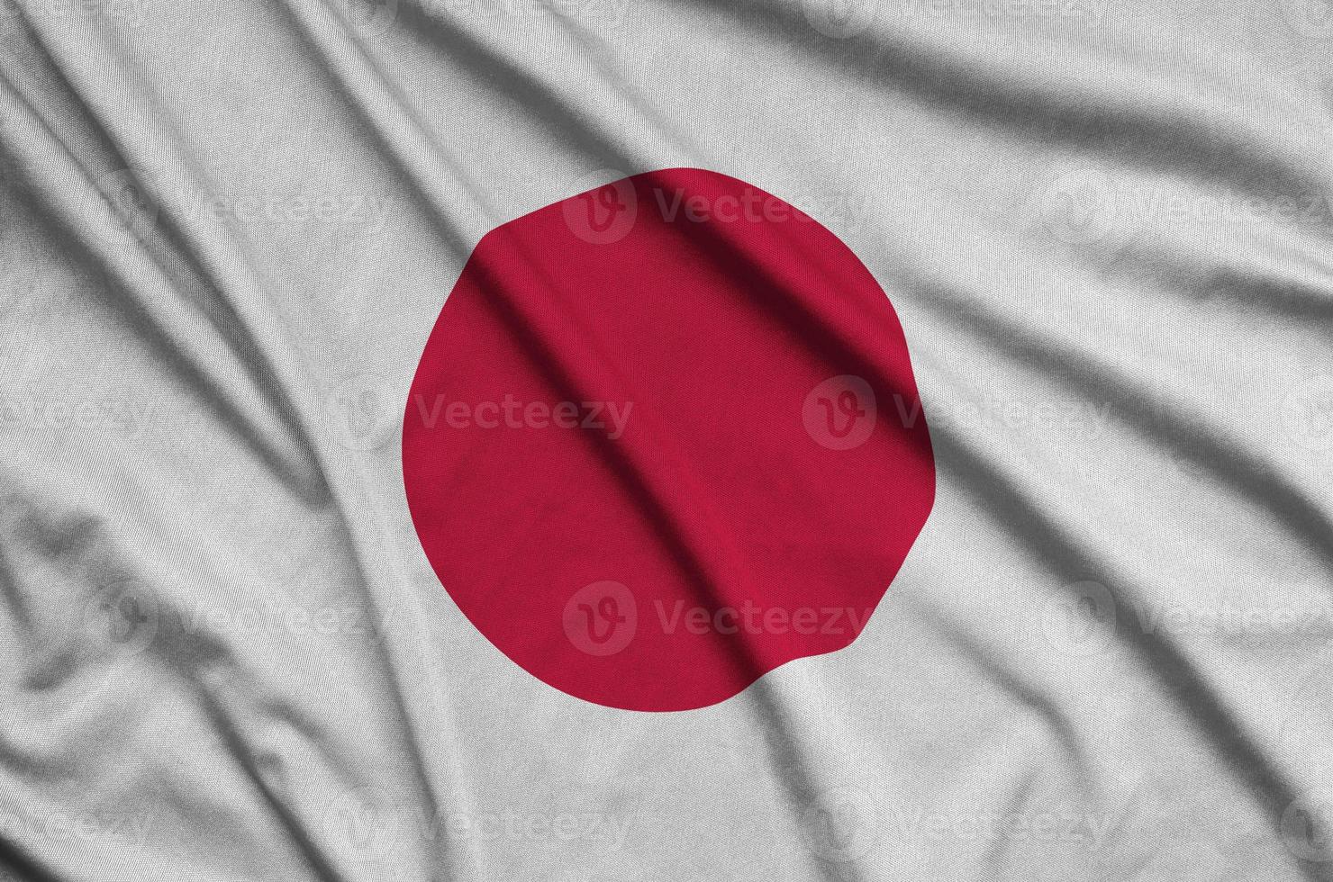 Japan flag  is depicted on a sports cloth fabric with many folds. Sport team banner photo