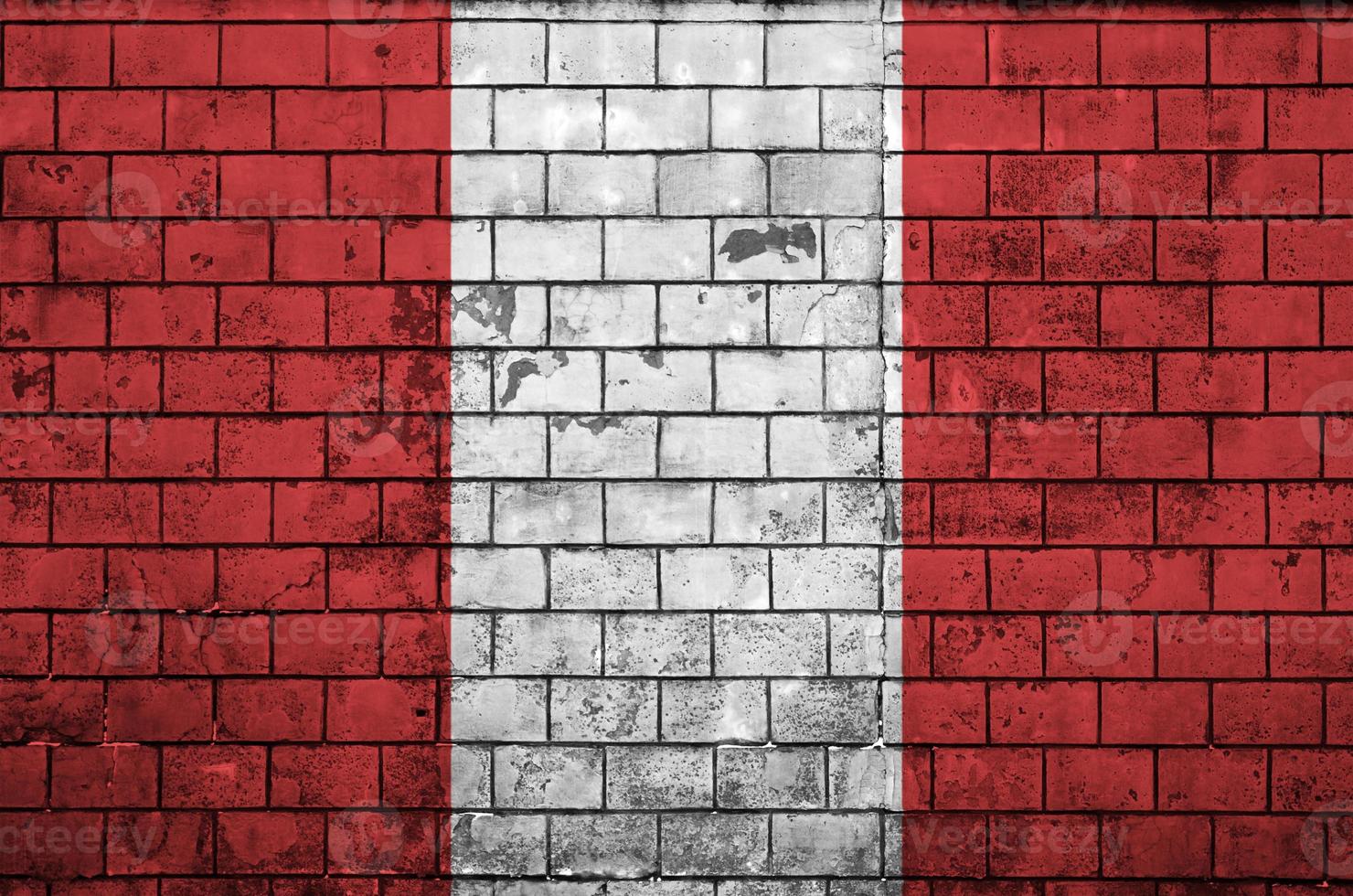 Peru flag is painted onto an old brick wall photo