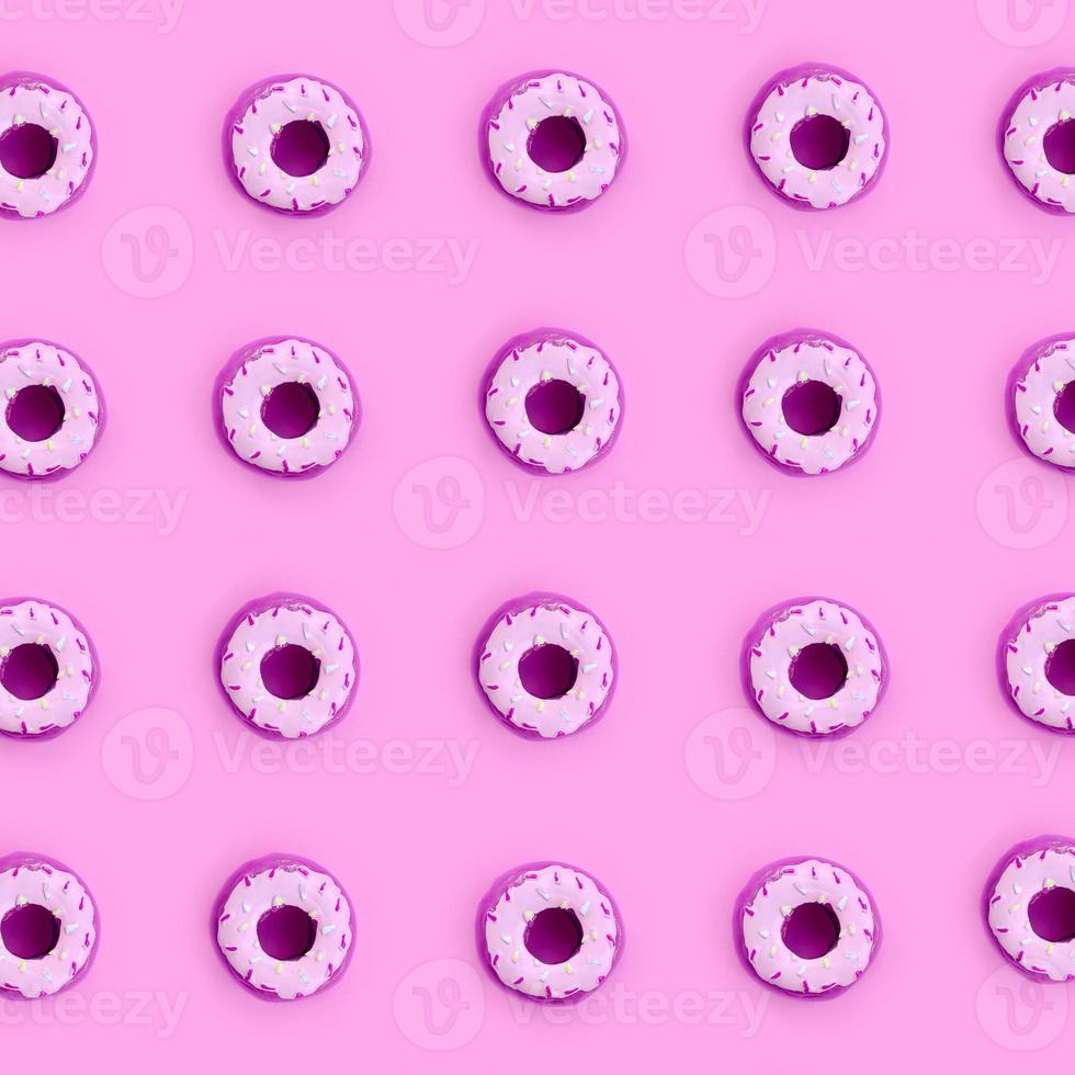 Many small plastic donuts lies on a pastel colorful background. Flat lay minimal pattern. Top view photo
