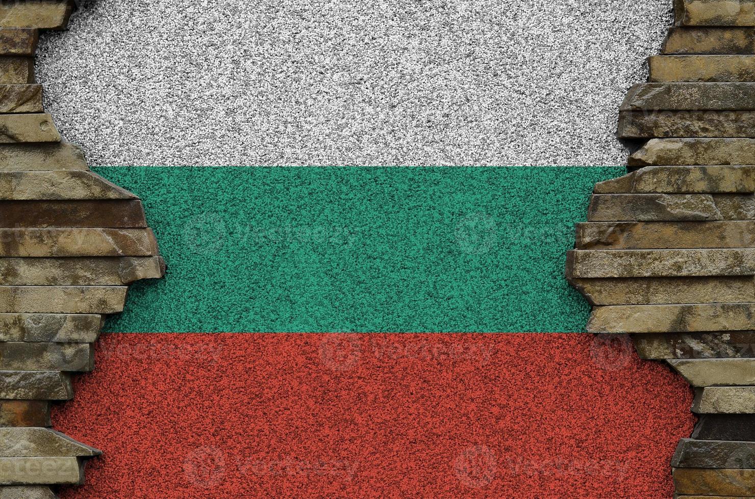 Bulgaria flag depicted in paint colors on old stone wall closeup. Textured banner on rock wall background photo