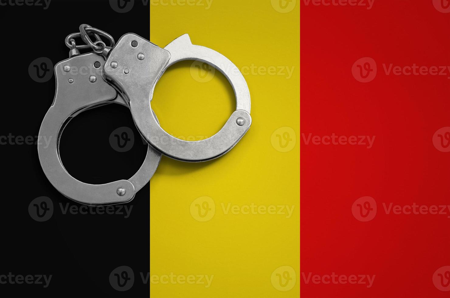 Belgium flag  and police handcuffs. The concept of crime and offenses in the country photo