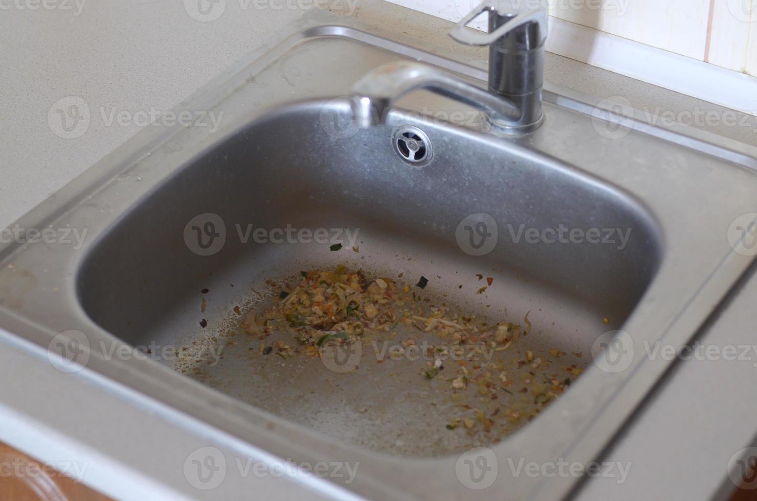 cerrar el desagüe sucio del fregadero de la cocina con partículas de comida foto