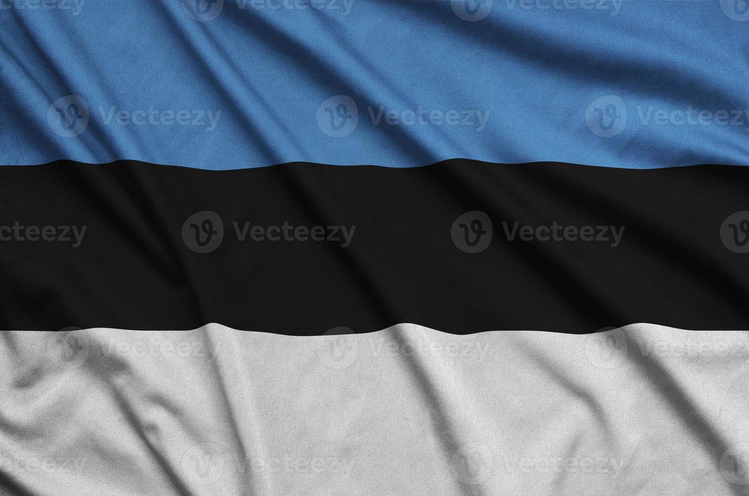 Estonia flag  is depicted on a sports cloth fabric with many folds. Sport team banner photo