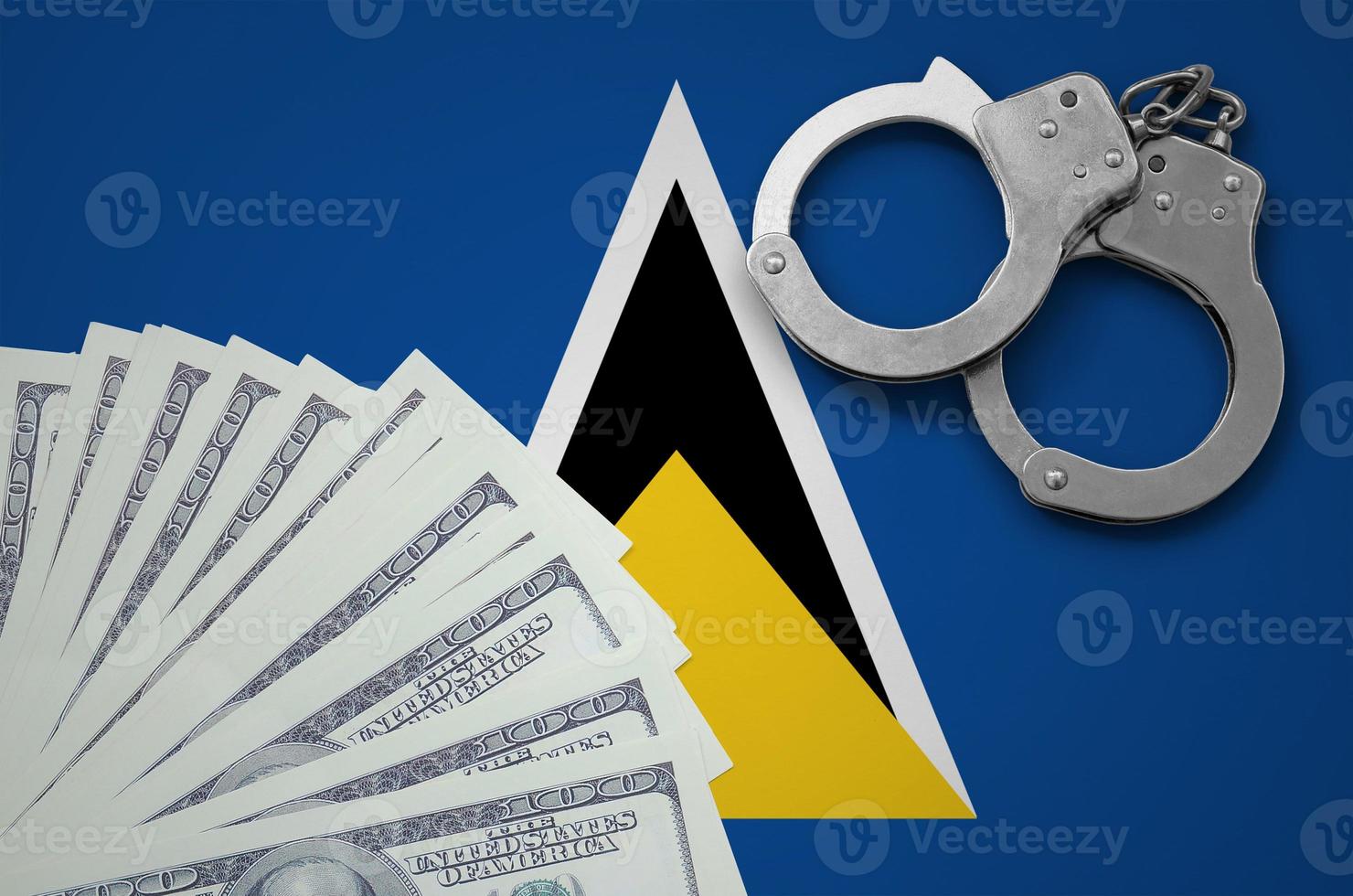 Saint Lucia flag  with handcuffs and a bundle of dollars. The concept of illegal banking operations in US currency photo