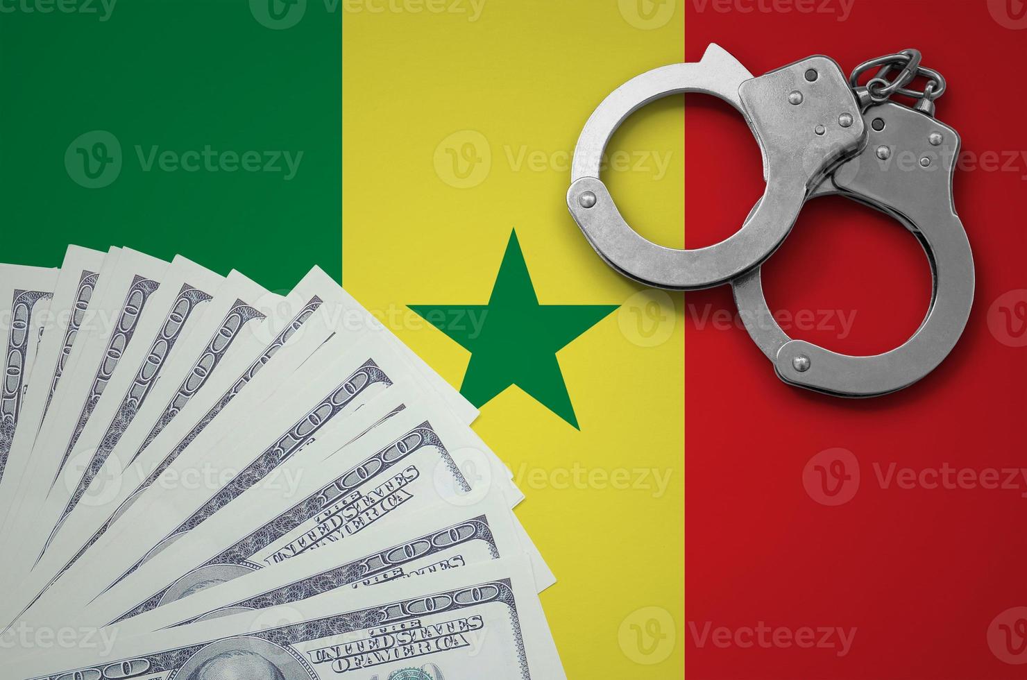 Senegal flag  with handcuffs and a bundle of dollars. The concept of illegal banking operations in US currency photo