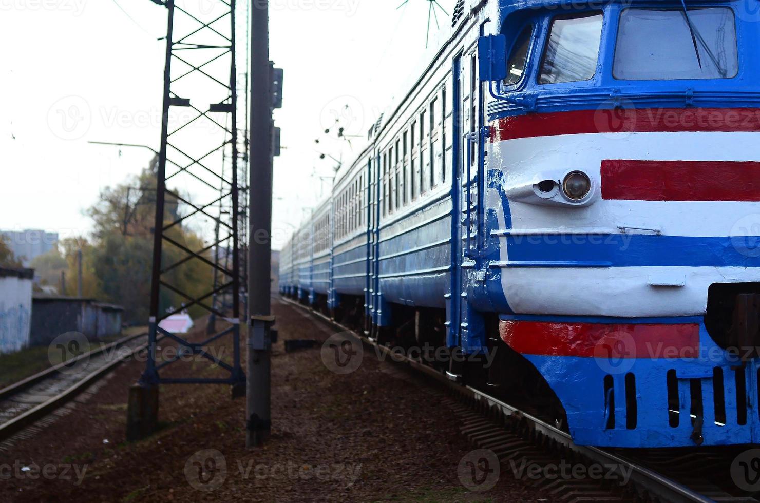 Old soviet electric train with outdated design moving by rail photo