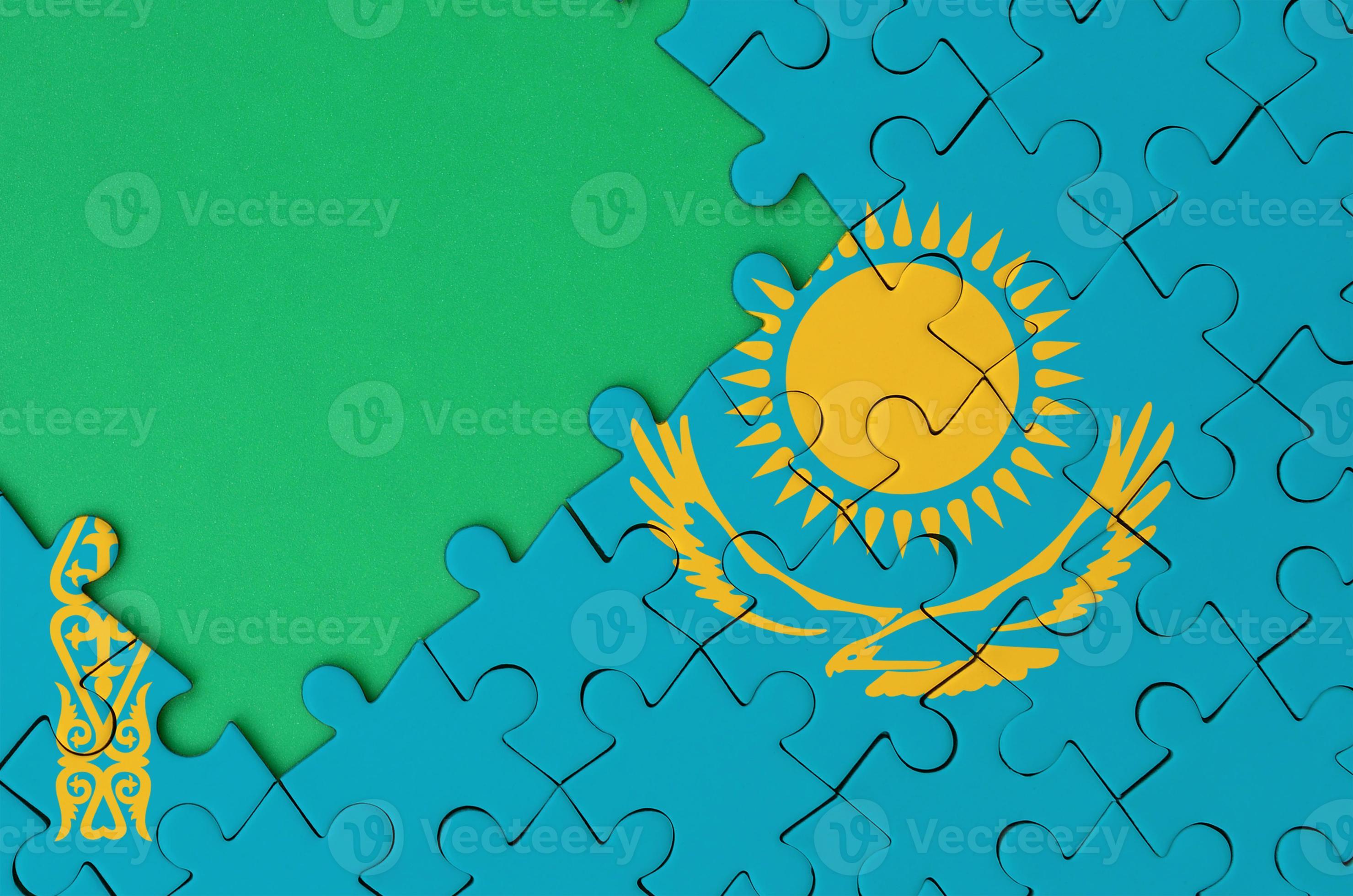 Kazakhstan flag is depicted on a completed jigsaw puzzle with free
