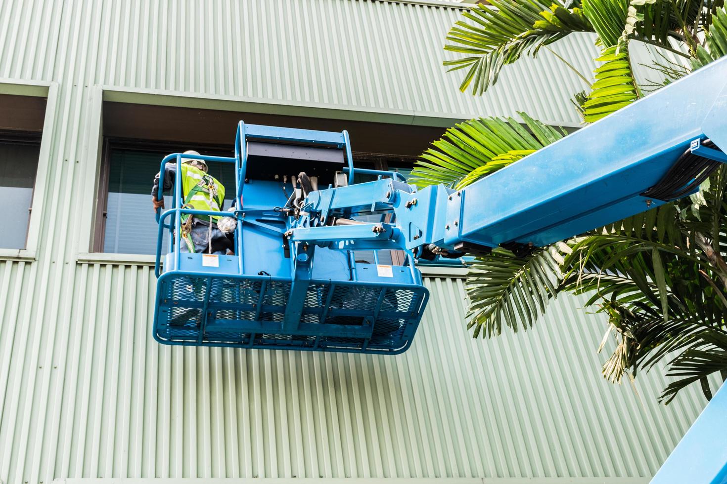 High-rise building maintenance engineers using cranes photo