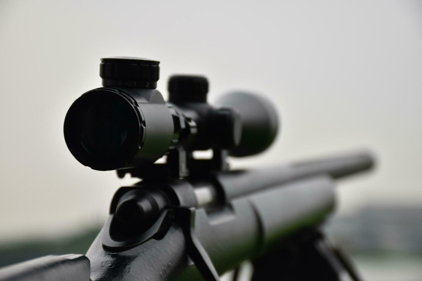 Rifle with a scope and bipod with first person shooter view photo