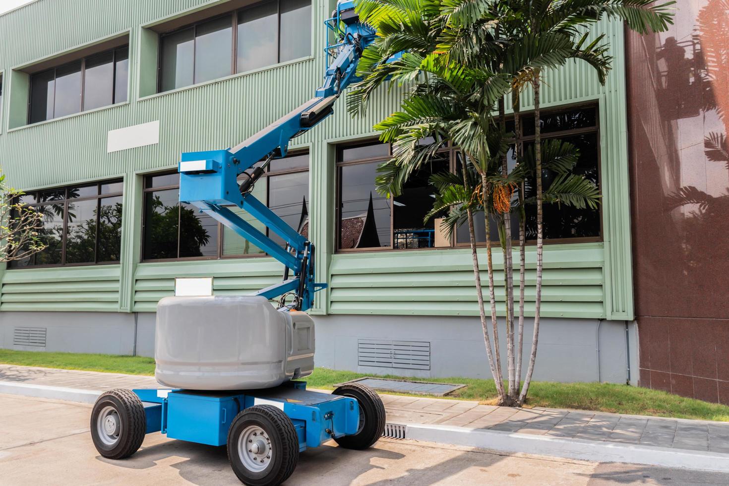 High-rise building maintenance engineers using cranes photo