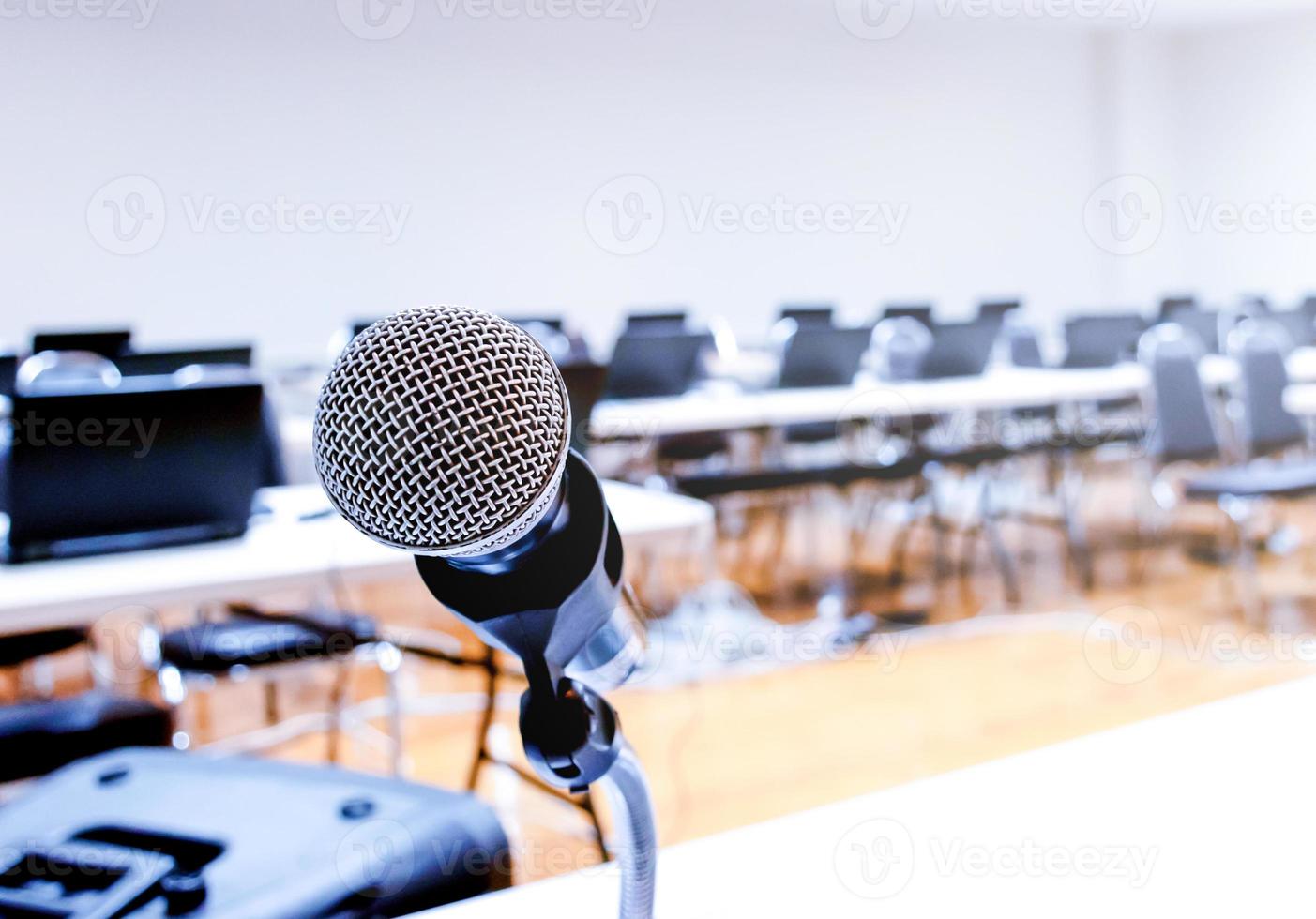Microphone and Notebook on abstract blurred of speech in seminar room photo