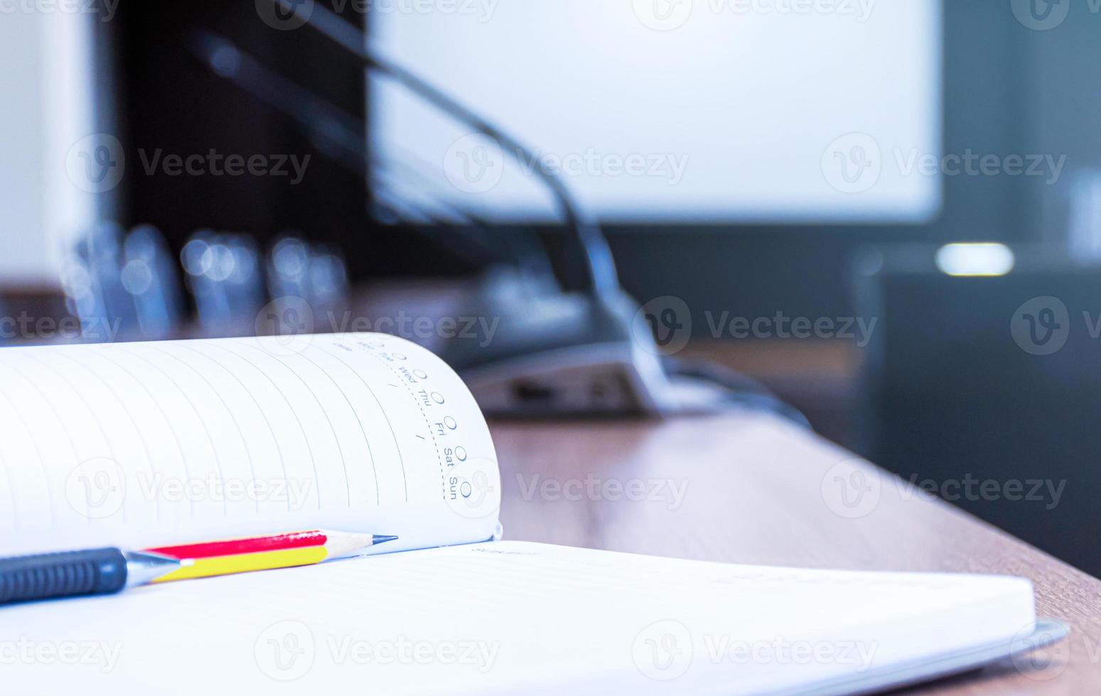 Notebooks with pencil and pen on the table in the meeting room photo