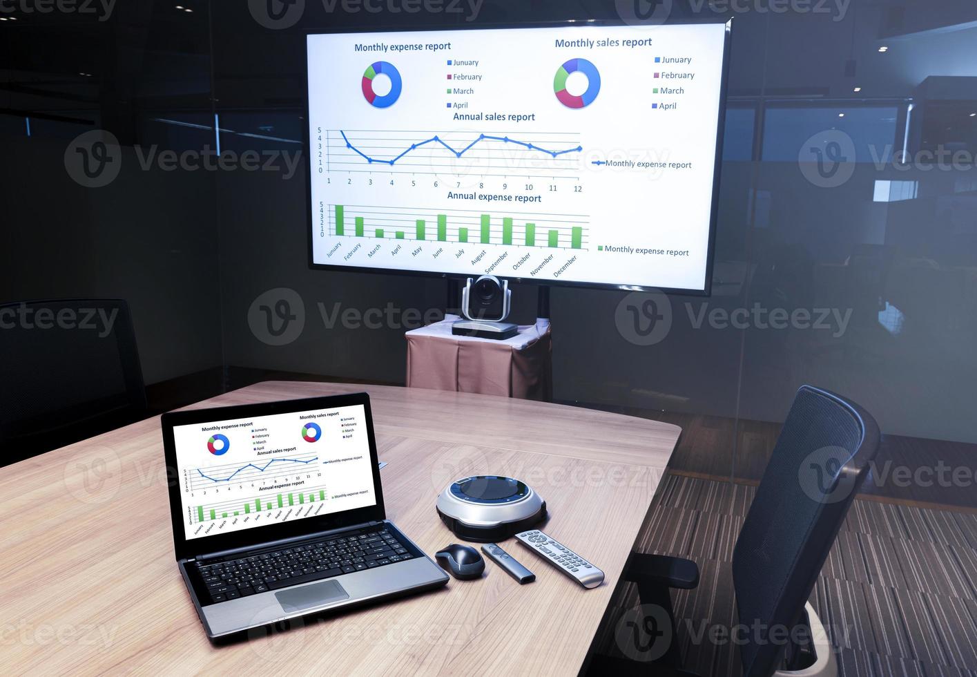 Presentation slide show on display television and laptop in meeting room photo