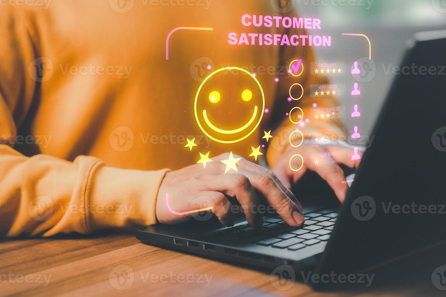 Man hand using computer laptop with popup five star icon for feedback review satisfaction service, testimonial. Customer service experience and business satisfaction survey. photo