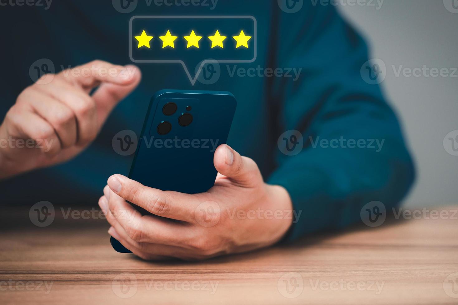Man using a smartphone in give rating to service experience on application. Online customer review satisfaction feedback survey and testimonial. photo