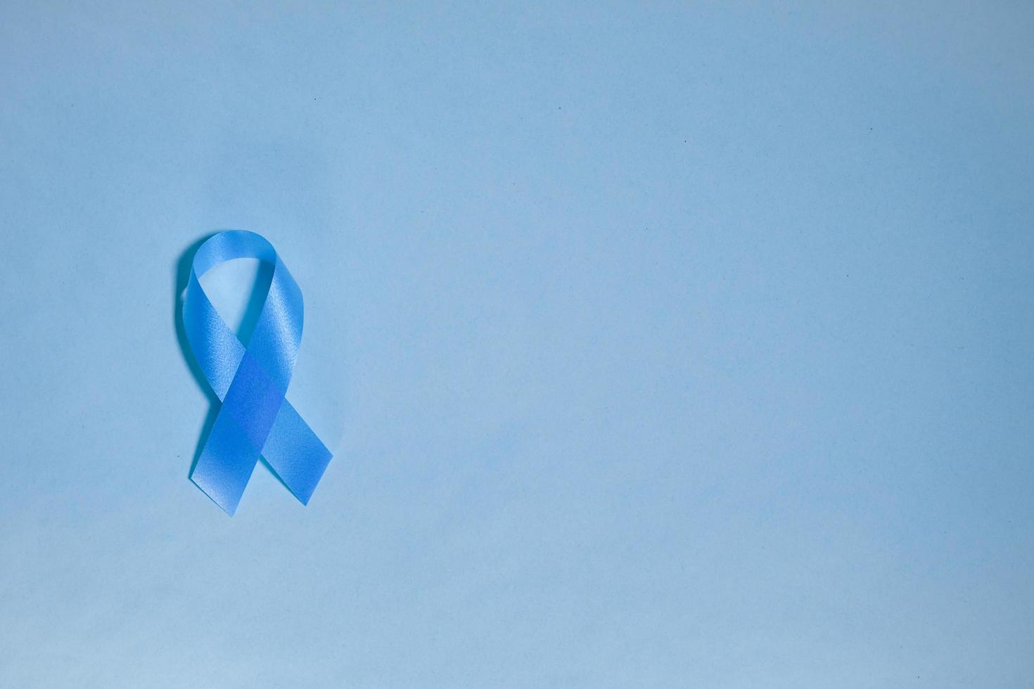 blue ribbon awareness World diabetes day,14 november. isolated on a blue background. Copy space. Top view photo
