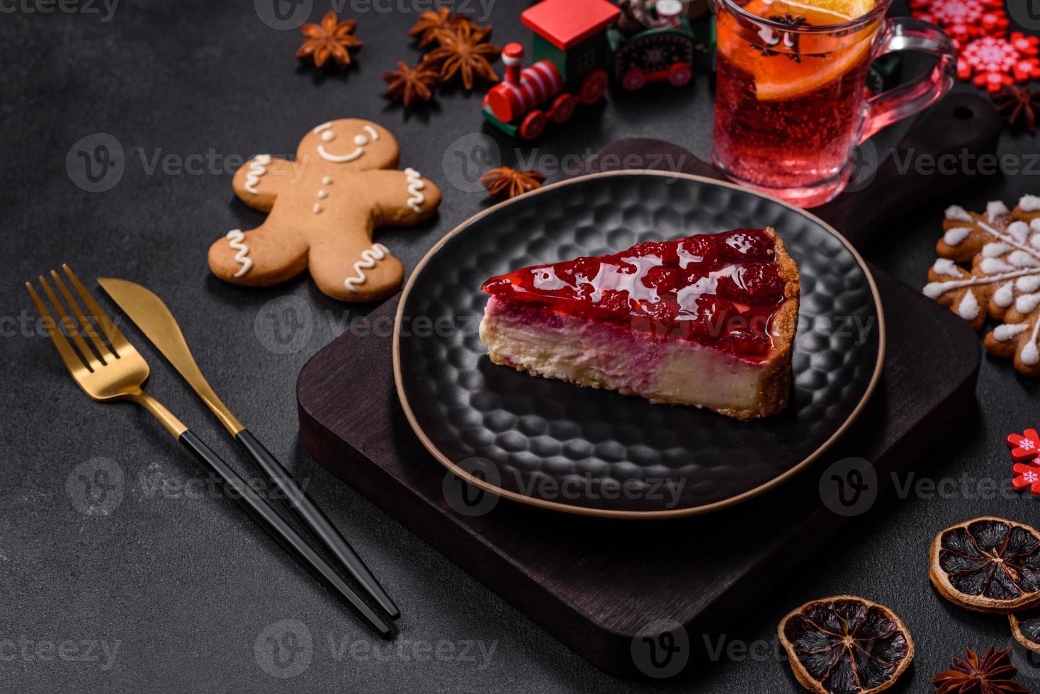 Homemade tasty cheesecake with jelly and raspberry berries on a black plate photo
