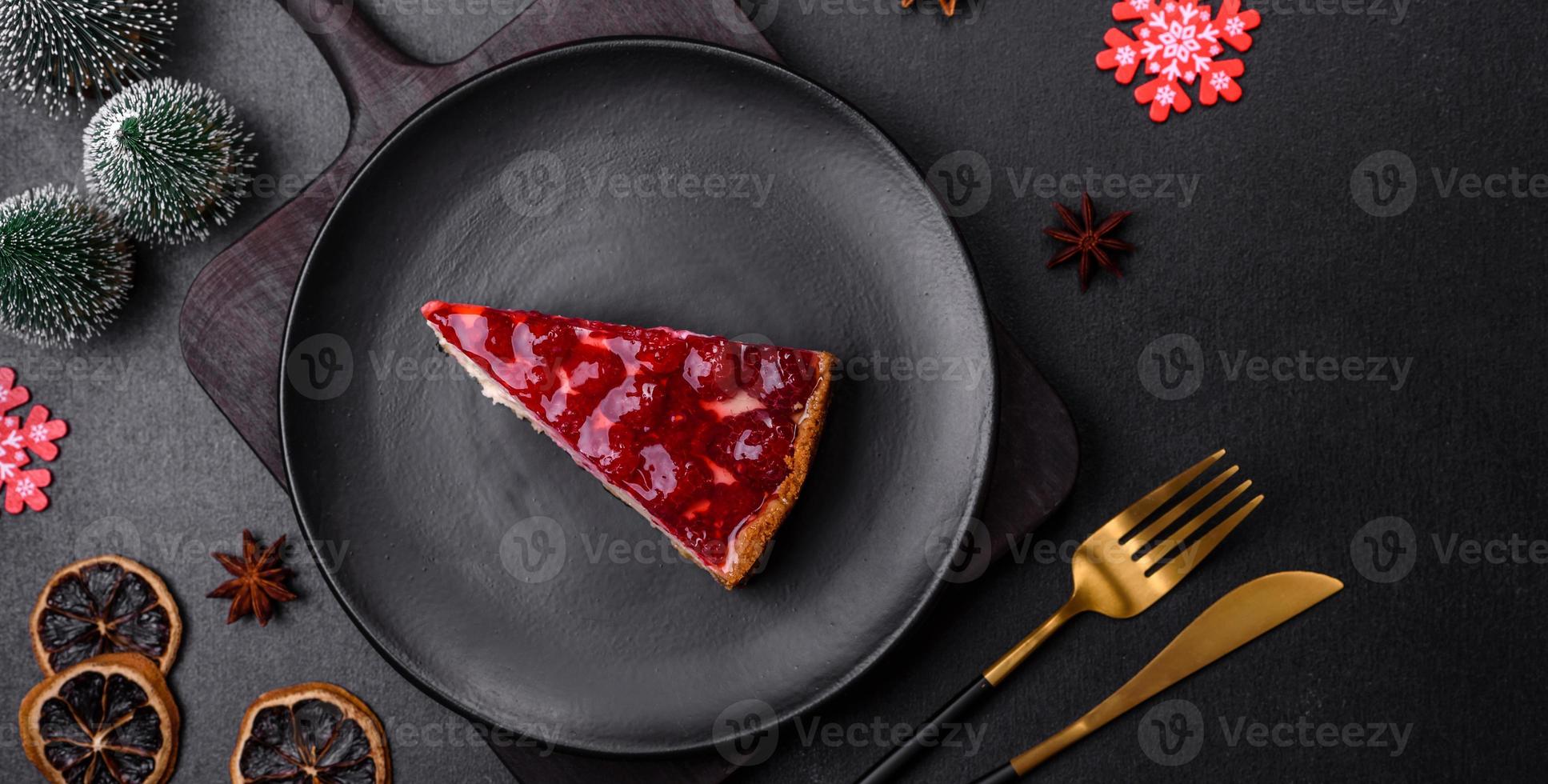 Homemade tasty cheesecake with jelly and raspberry berries on a black plate photo