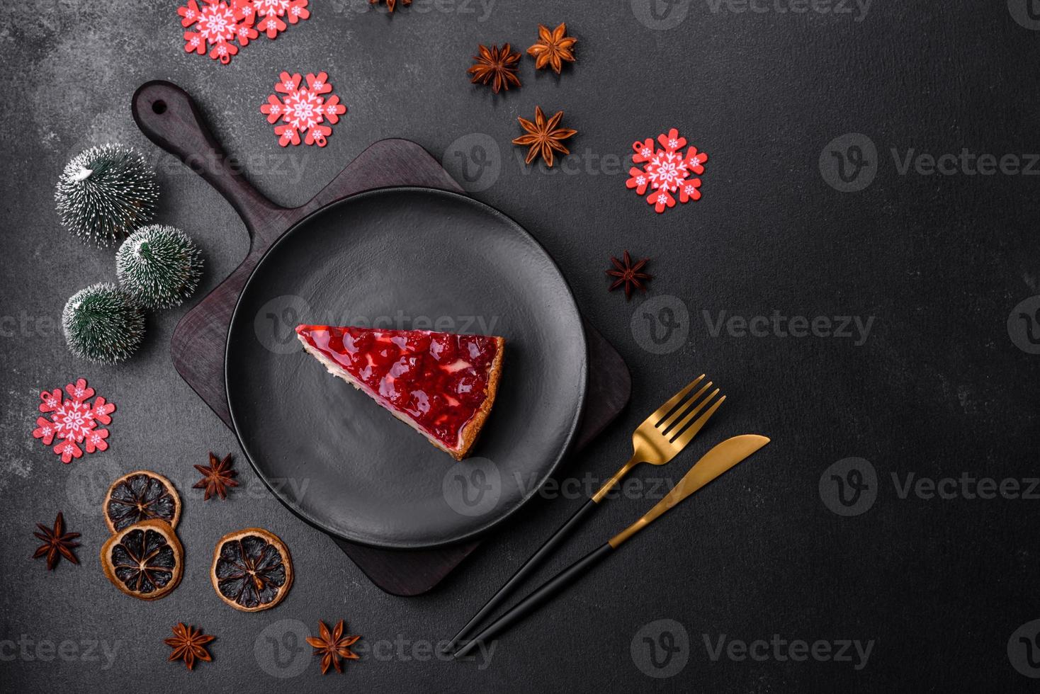 Homemade tasty cheesecake with jelly and raspberry berries on a black plate photo