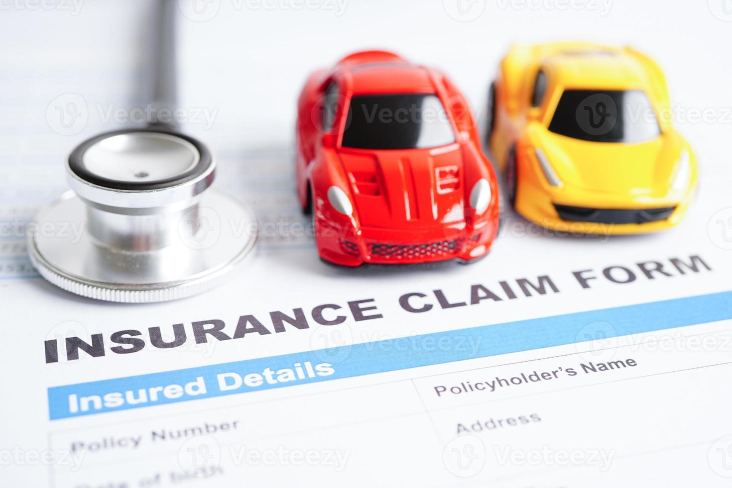 Stethoscope on Insurance claim accident car form, Car loan, insurance and leasing time concepts. photo