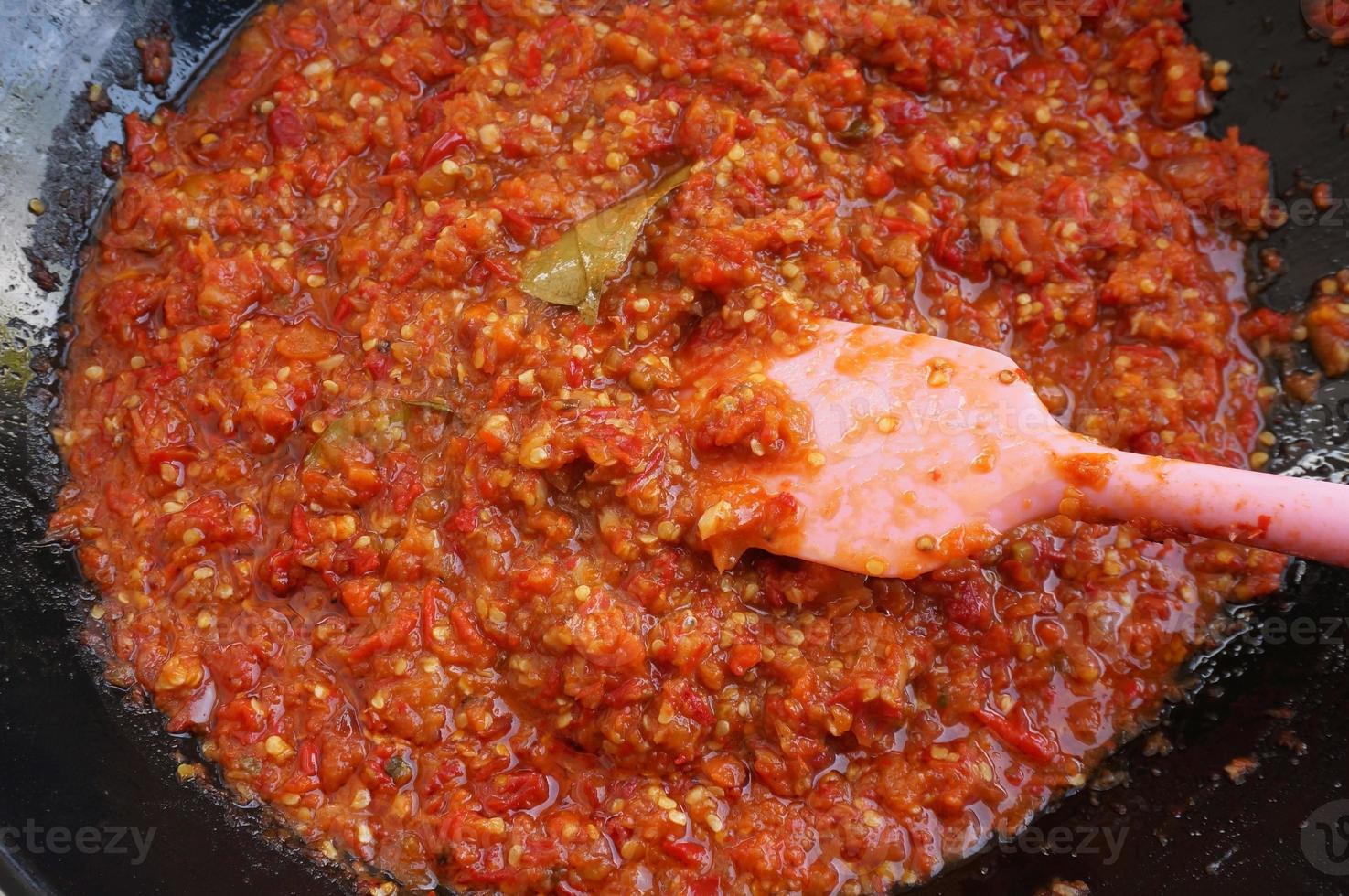 sambal tumis or sambal goreng is indonesian stir fried chili sauce. Ingredient is chili, salt, garlic, shalot and lime leaves. photo