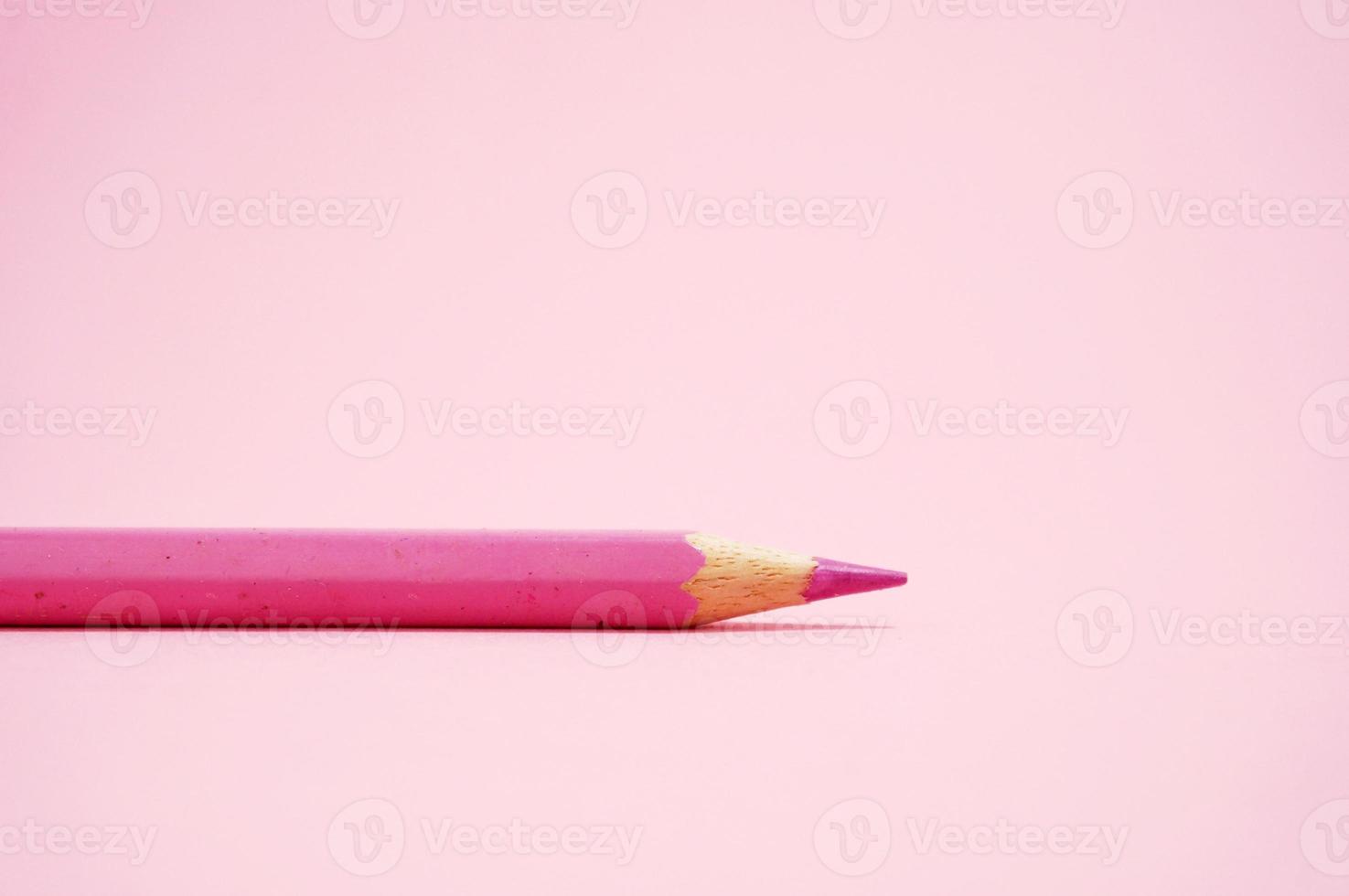 Pink Colored Pencil isloated on pink background. photo