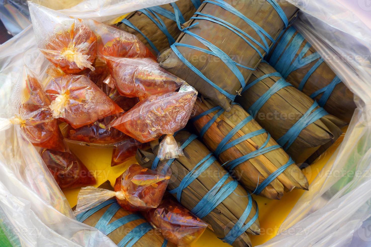 Burasa or buras is a type of Indonesian rice dumpling, originating from Indonesia, cooked with coconut milk packed inside a banana leaf pouch. photo