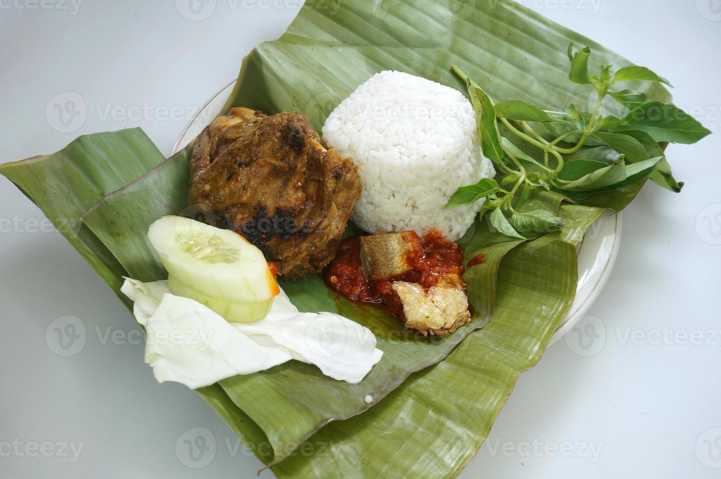 Nasi timbel is a popular Sundanese dish in West Java and Banten. This food is usually made from bagolo rice or mixed brown rice cooked in a banana leaf wrap photo