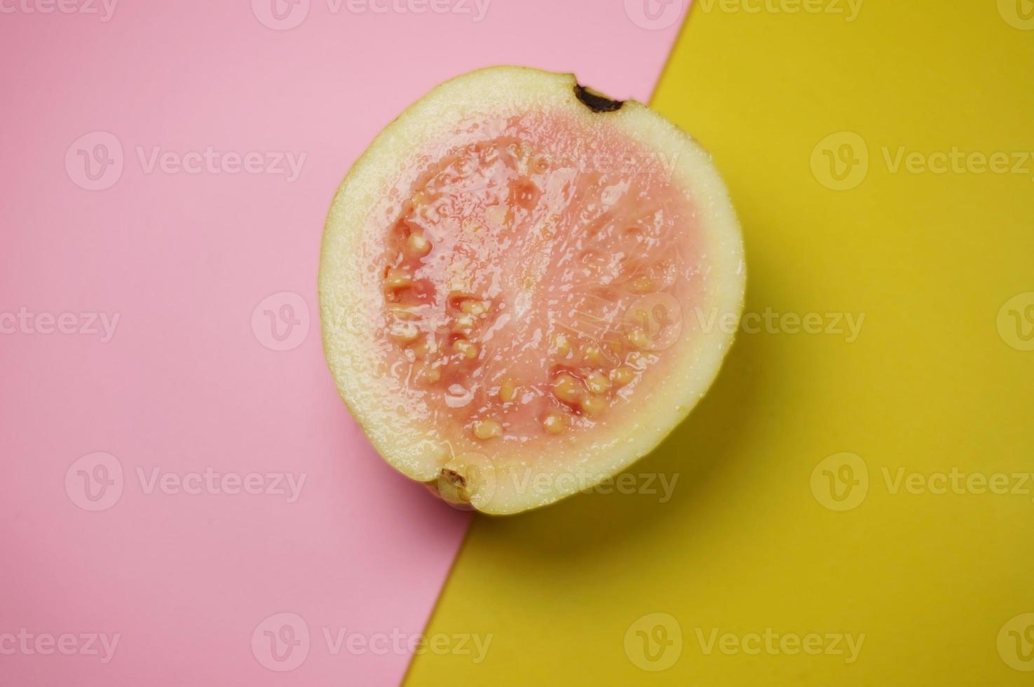Guava fruit  on pink and yellow background with selective focus. photo