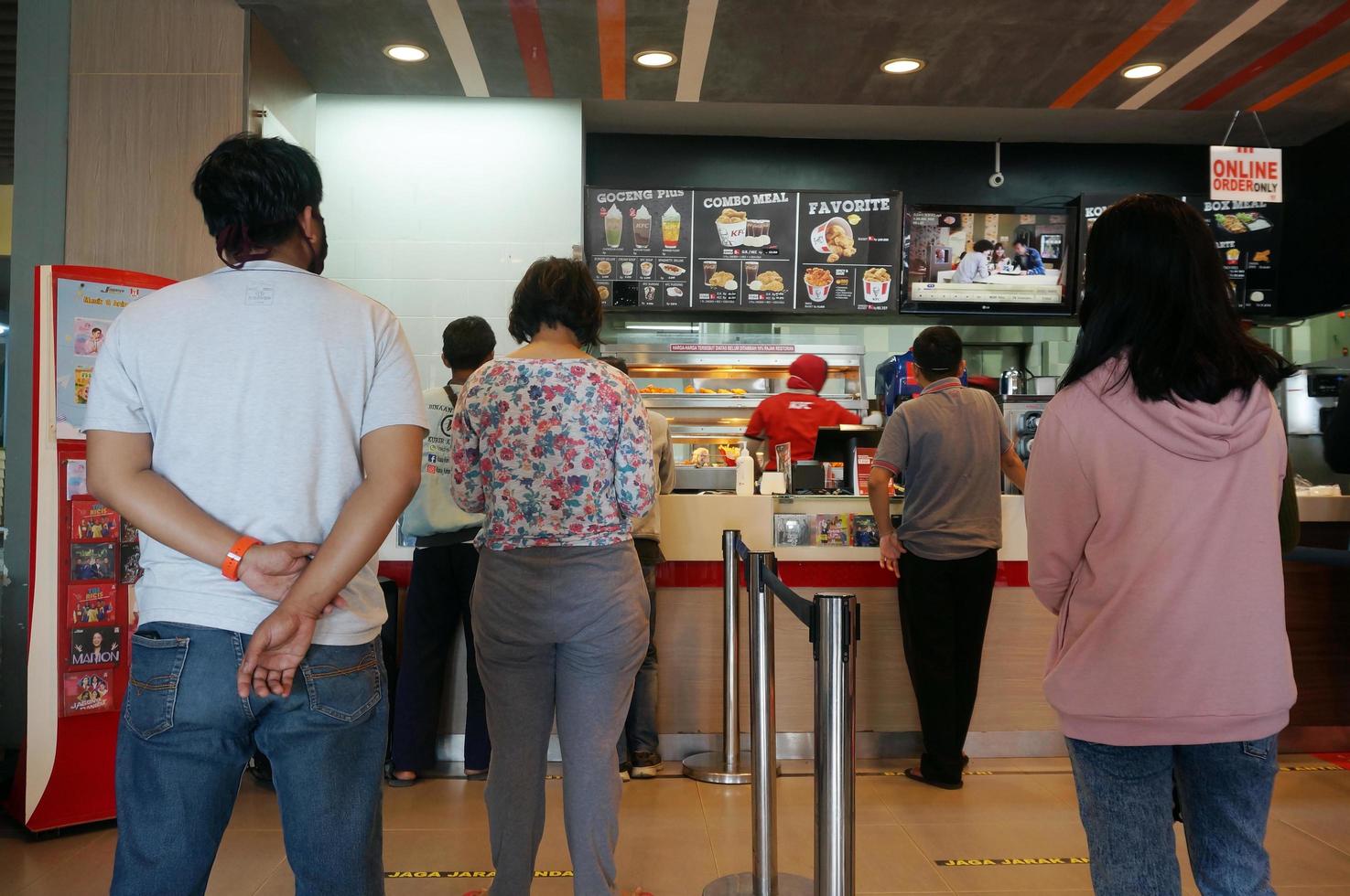 Sangatta, East Kalimantan, Indonesia, 2020 - physical distancing. keep a safe distance.Preventive program and action Covid19 in Kentucky Fried Chicken Restaurant. photo