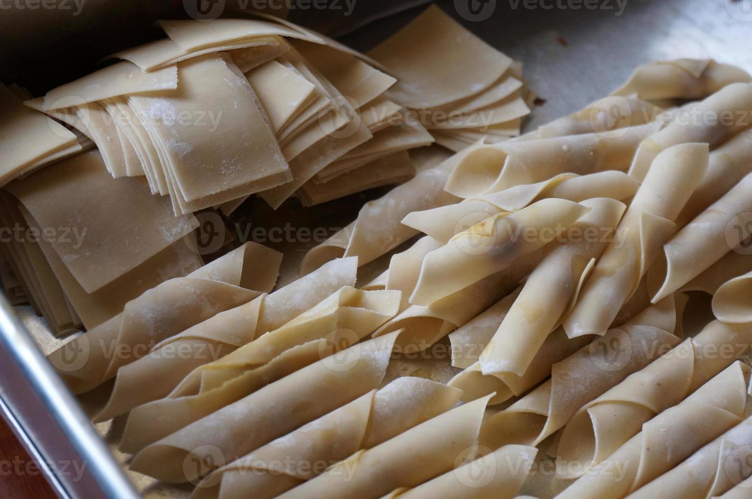The process of making or cooking an kacang sembunyi , Popular snack from indonesia. Beans wrapped in a dough skin from flour . Deep fried using oil and  liquid sugar. photo
