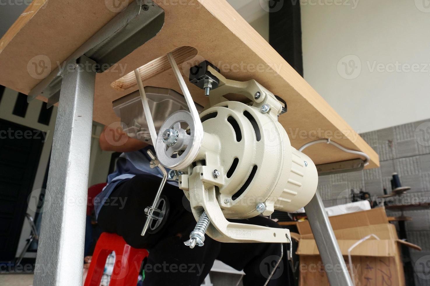 rofessional electric sewing machine located in sewing workshop photo