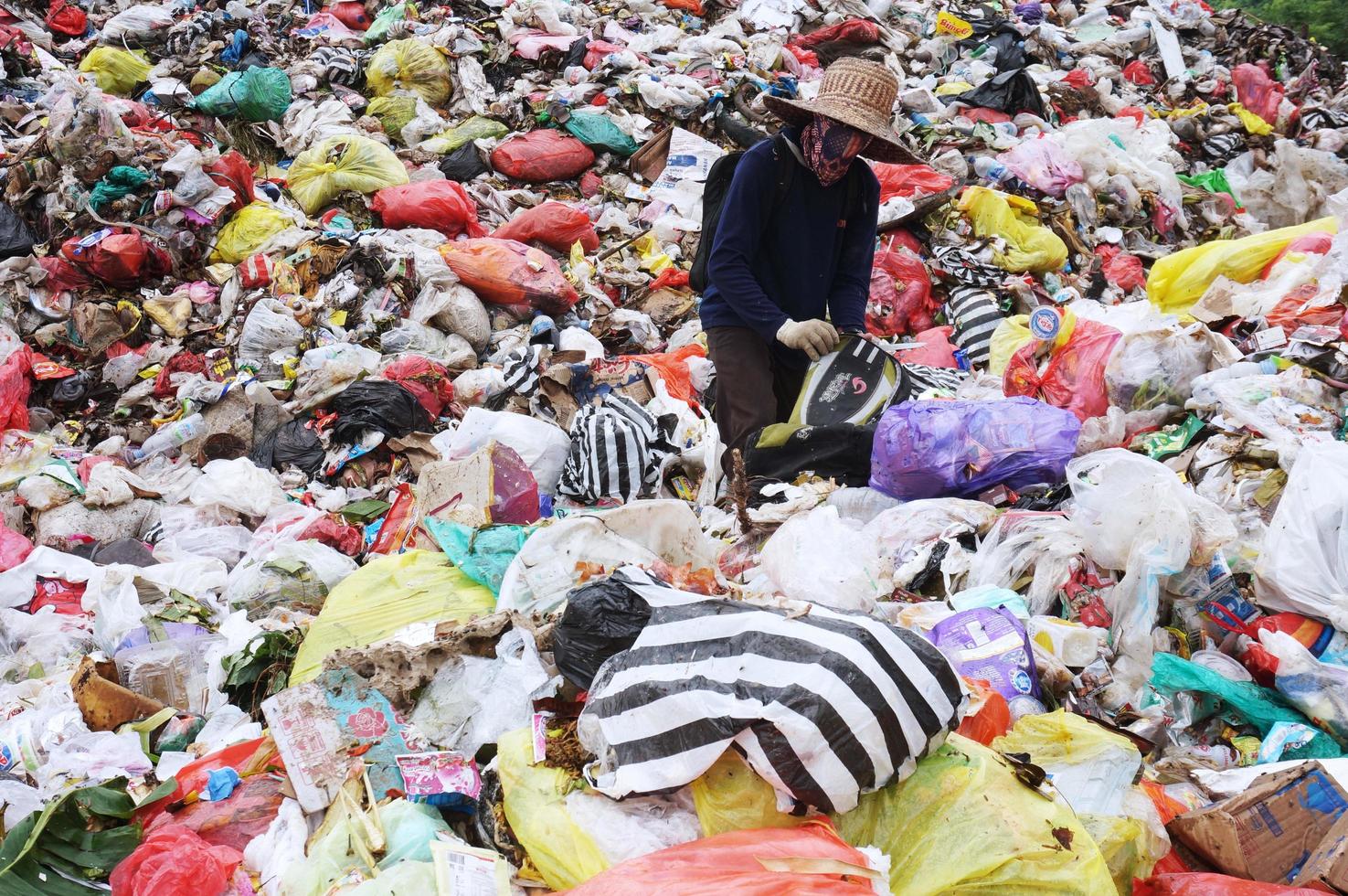 Sangatta, East Kalimantan, Indonesia, 2020 -a scavenger man is sorting out items that are still fit for use or sale photo