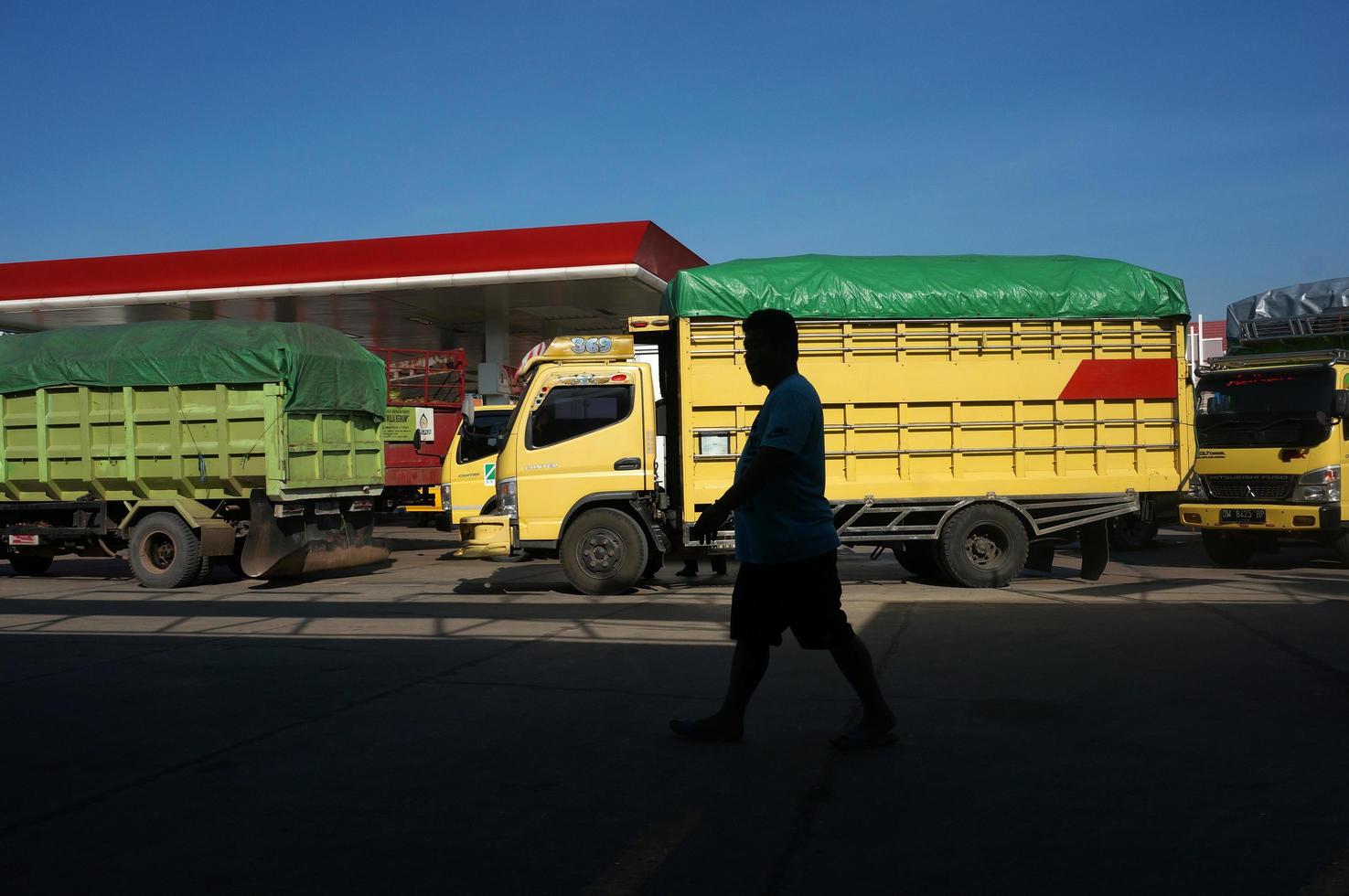Sangatta, East Kalimantan, Indonesia, 2020 - SPBU is Stasiun Pengisian Bahan Bakar Umum or Gas Station. A queue of transport trucks to refuel diesel fuel photo